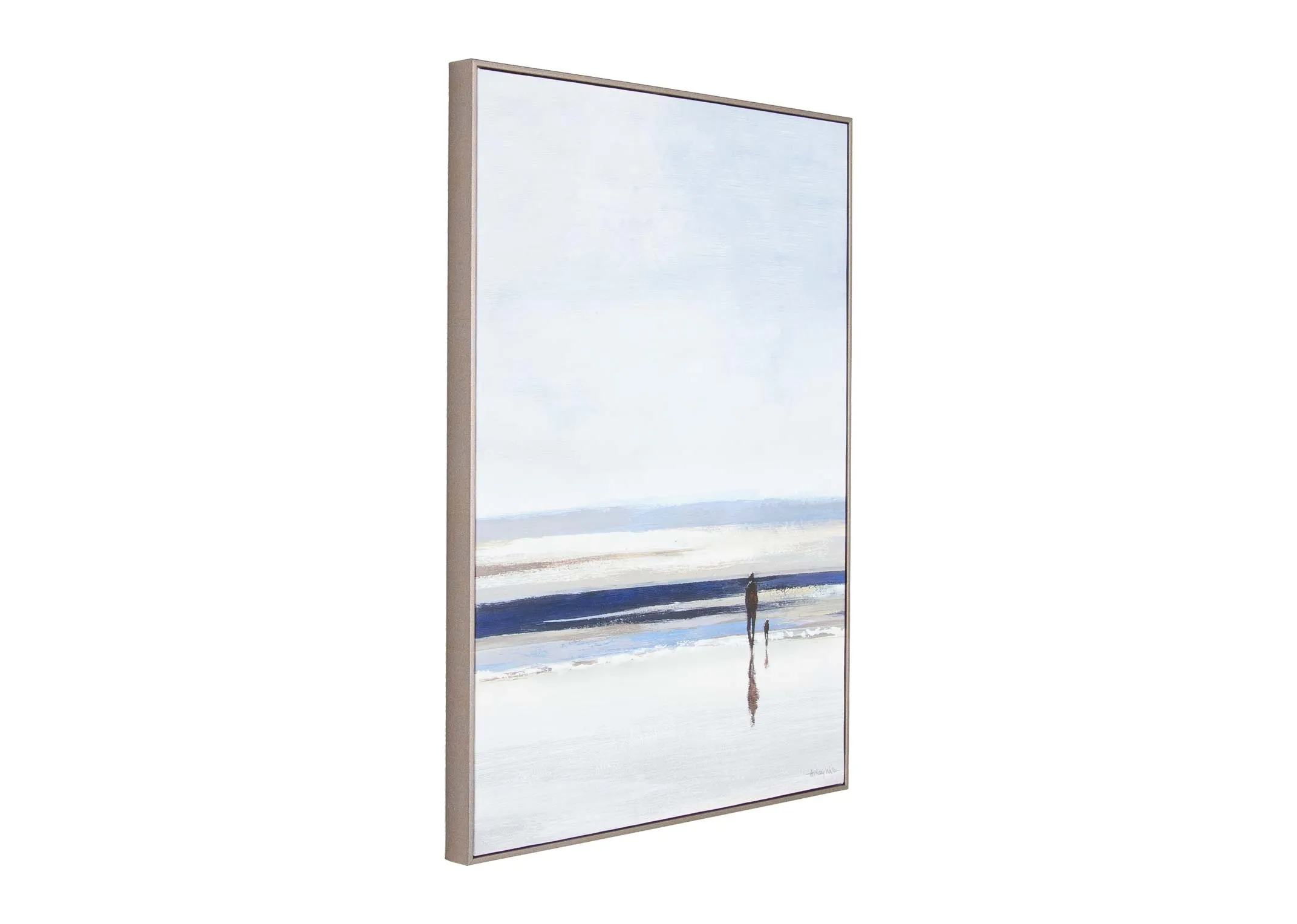 A silver framed canvas of an ocean with a person strolling toward from EZ Living's Shoreline range. Angled view