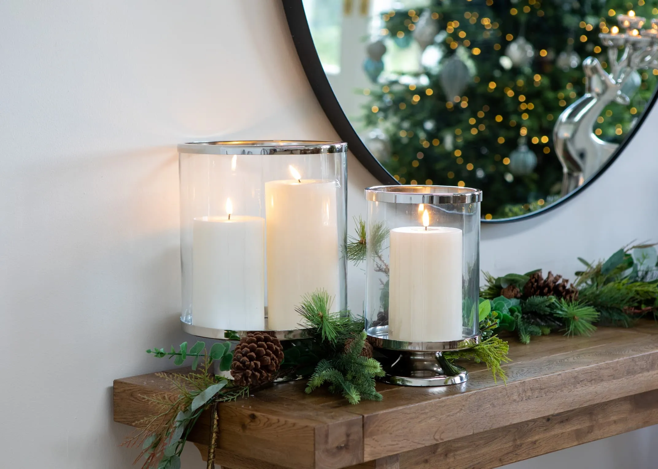 A lifestyle image of the Athens Console table with Pillar Hurricanes in small & large