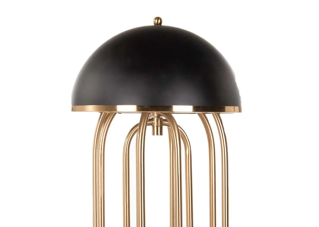 A gold metal art deco table lamp with black hard shade from EZ Living's Dixie range. Closeup view of black base & gold metal 