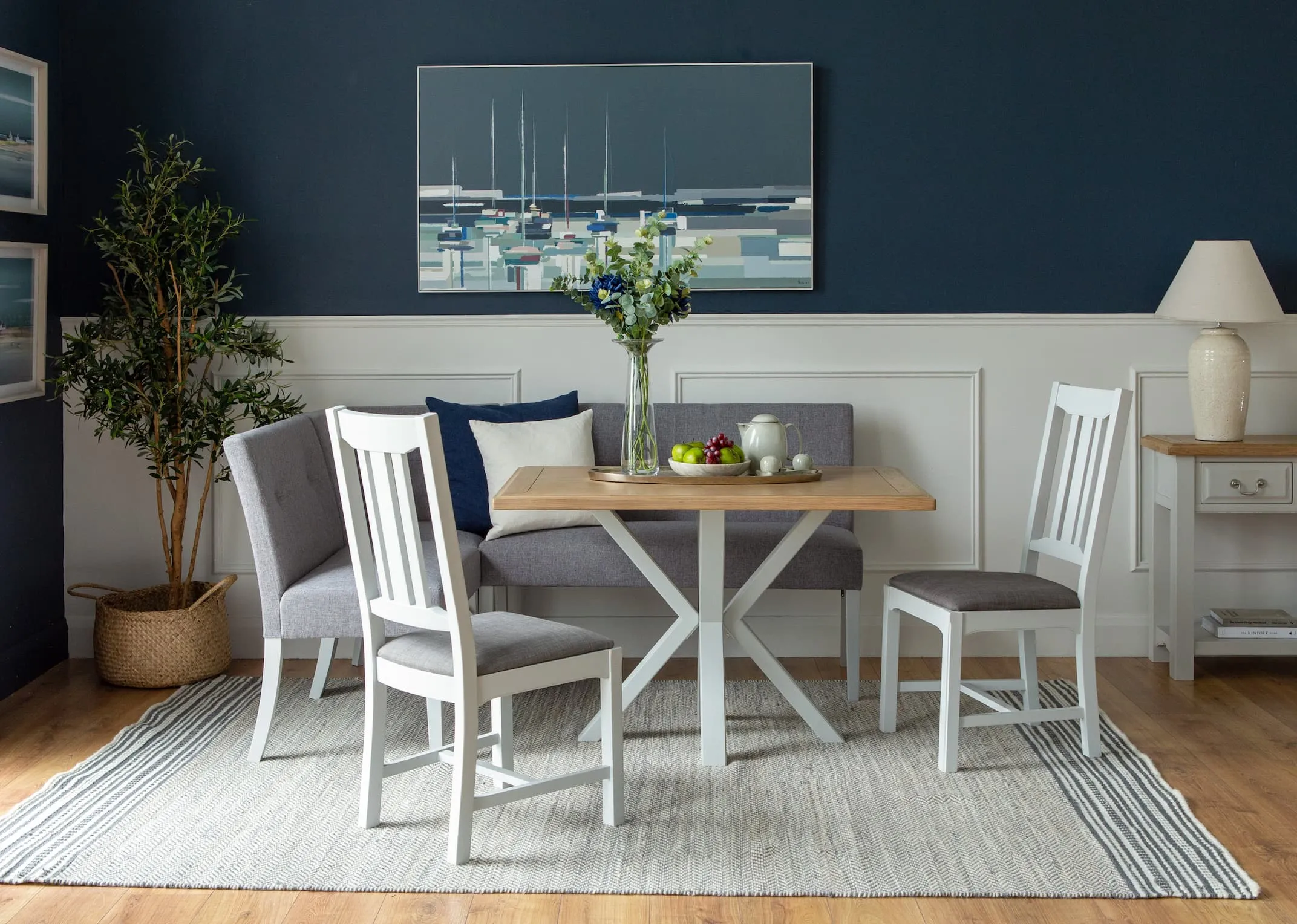 A lifestyle image of the Georgia dining table with chairs & corner bench.