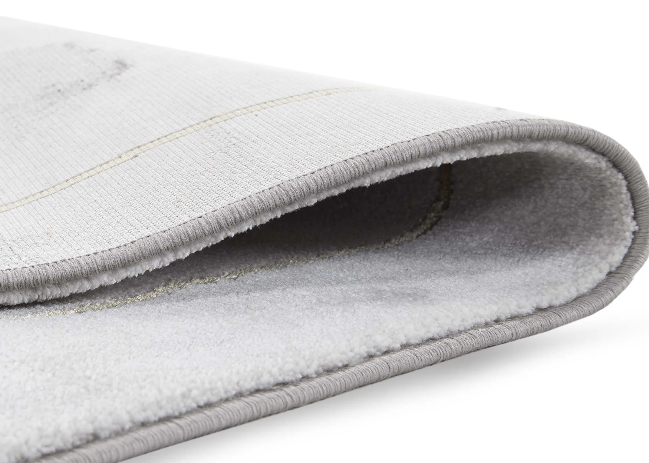 A grey sofa rug with gold geometric lines from EZ Living Furniture's Avery range. Front view of ombre style grey.