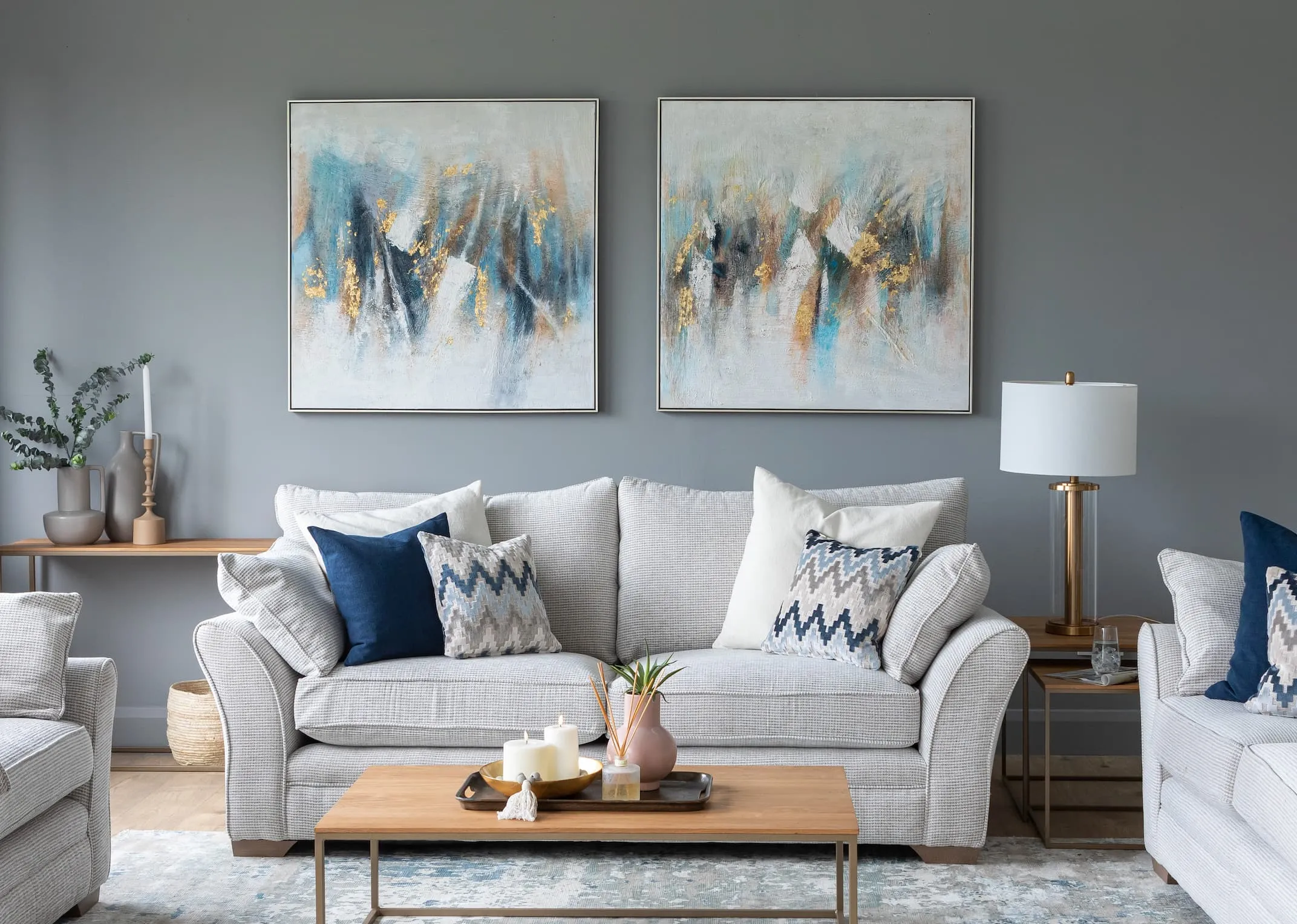 A lifestyle image of the Strata Sofa range with aston tables & Abstract & Abstract take 2 canvas prints with visby lamp.