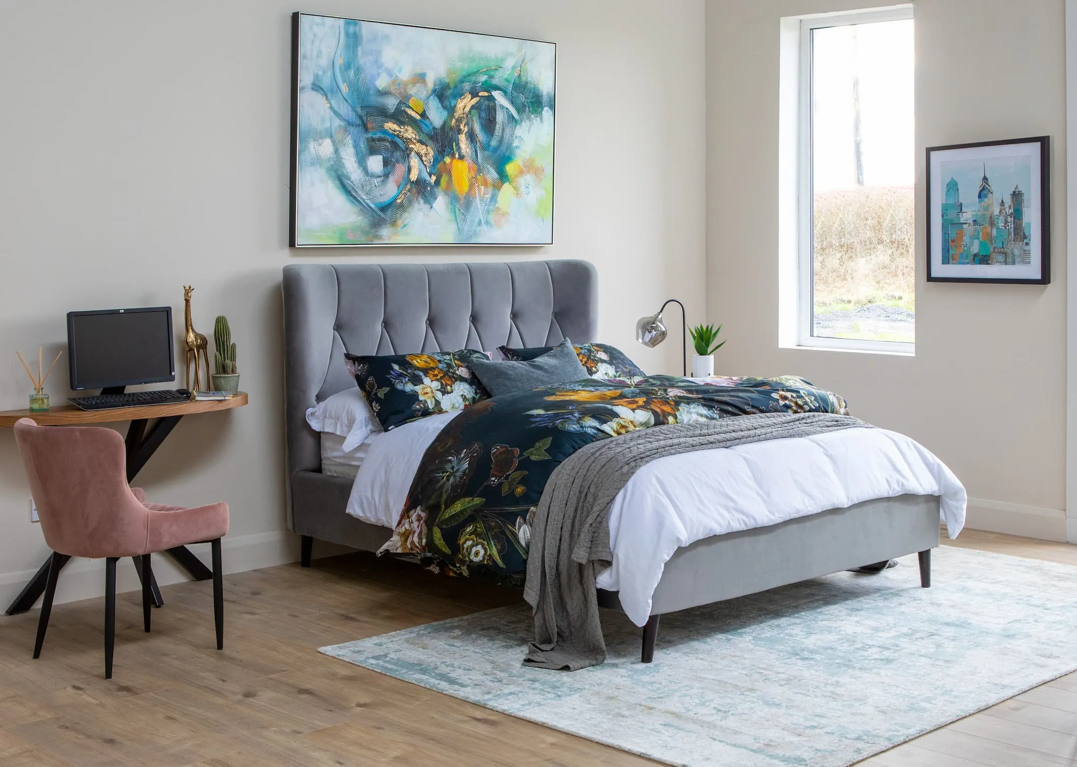 A lifestyle image of the Silver Garcia bed with ottowa chair & ellipse console and infusion print.