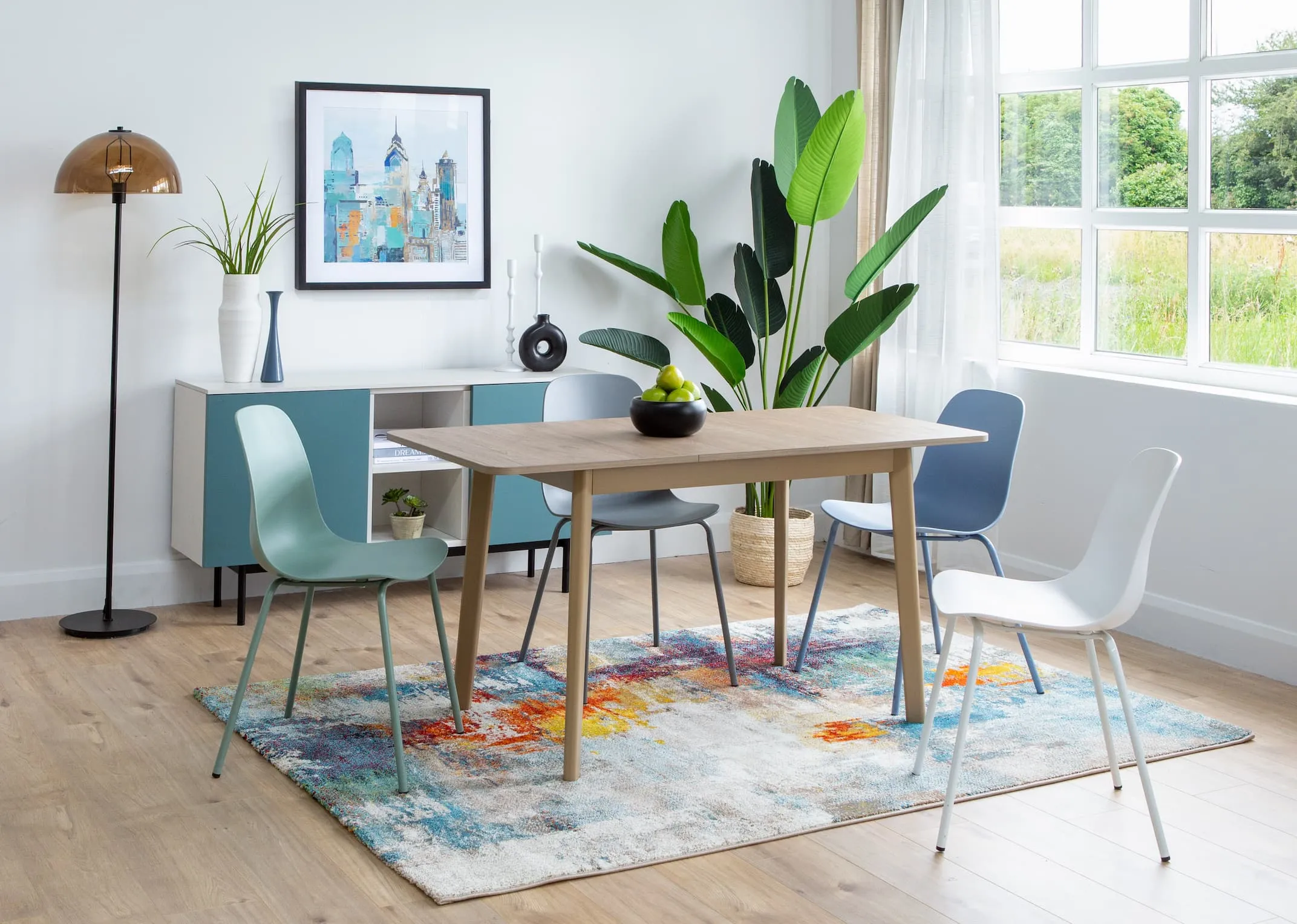 A lifestyle image of the Dine table with Whitby chairs & Abstract rug