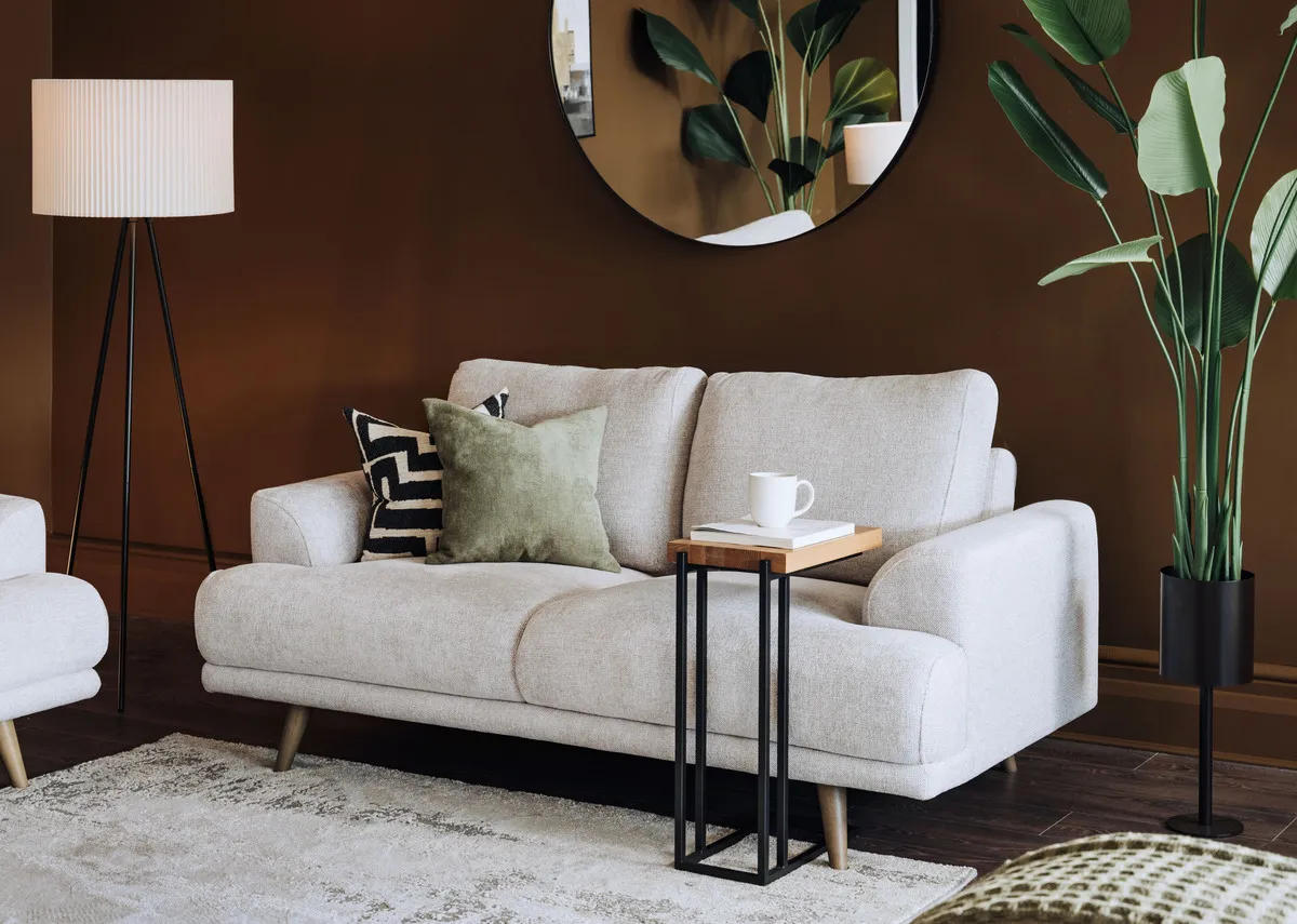 A lifestyle image of the Legend sofa with side table