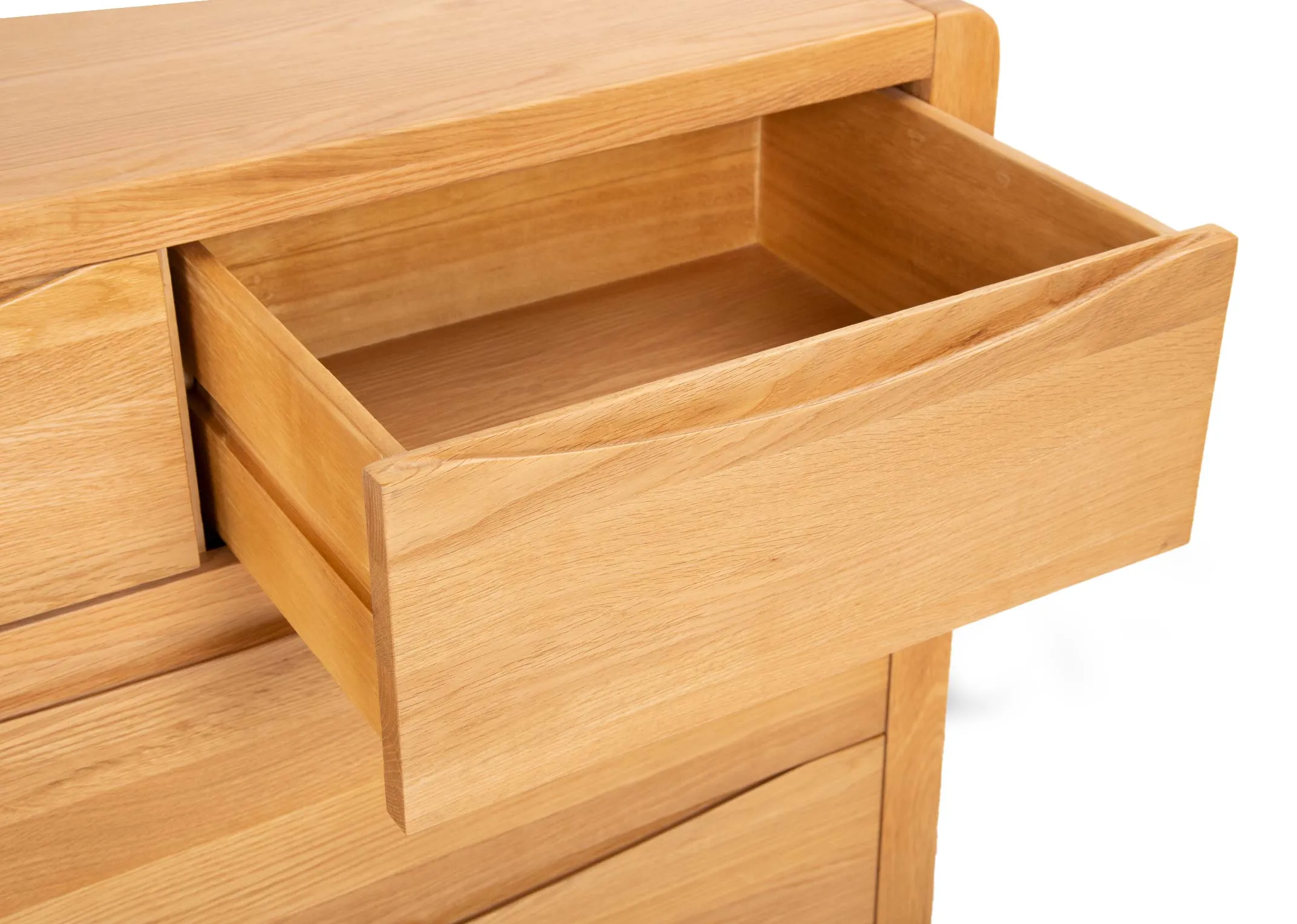 An oak chest of drawers from EZ Livings Iris range. Angled closeup of soft close drawer