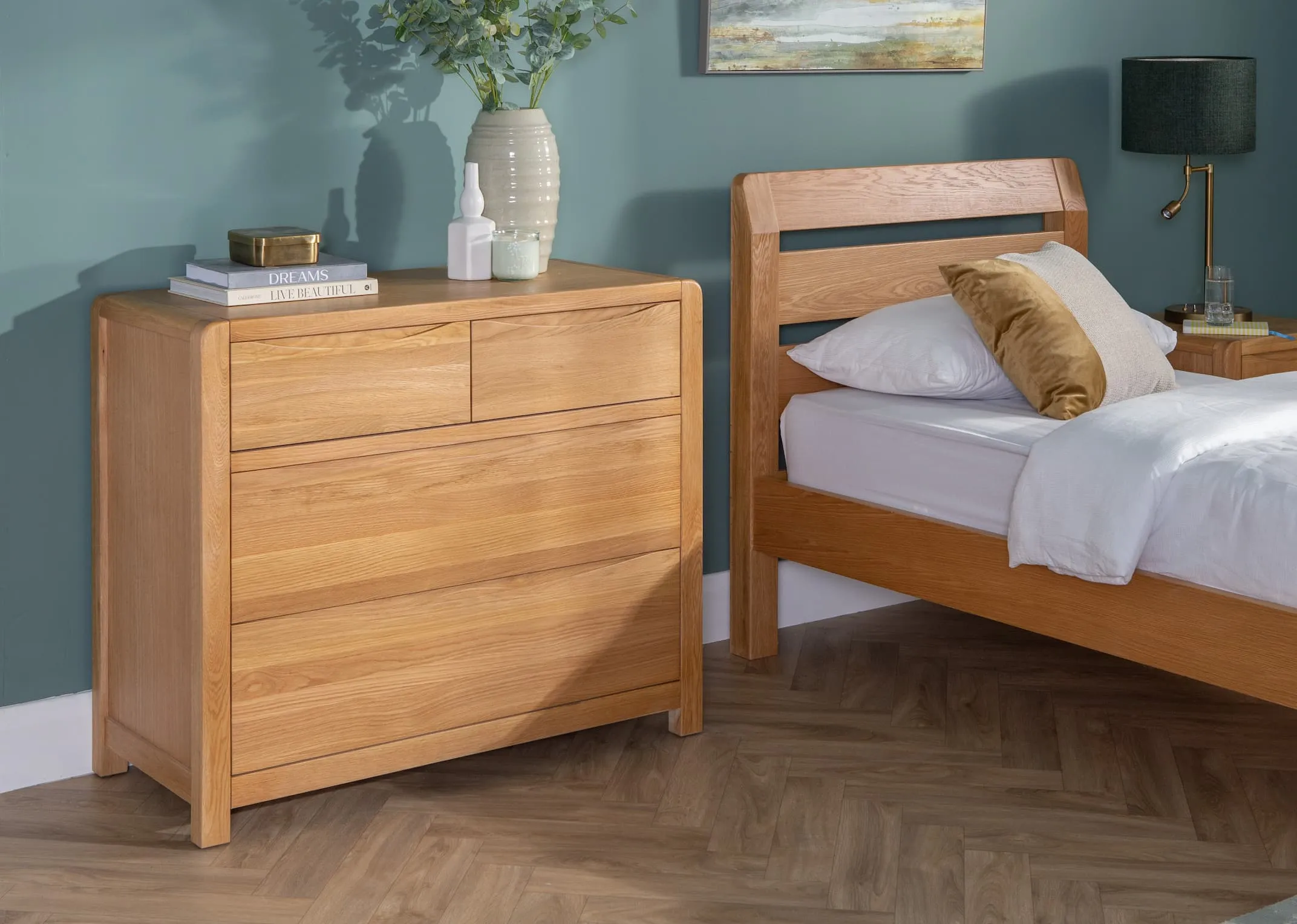 A lifestyle image of the Single Iris bedframe with 4 drawer oak chests with western Glow canvas