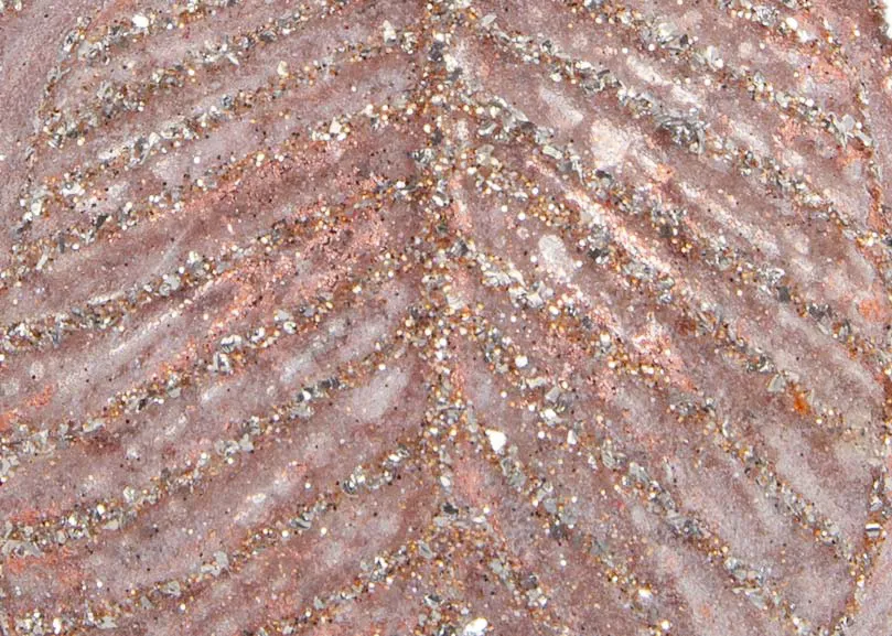 A large pink bauble with sparkling detail from EZ Livings Christmas range. Closeup pf texture detail