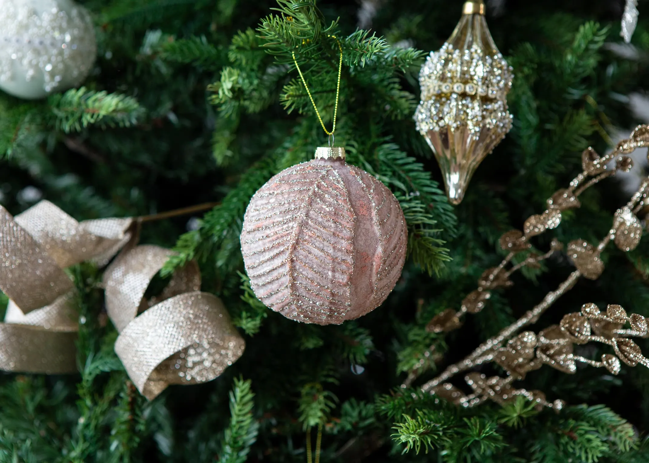 A lifestyle image of the Pink Round Bauble on an EZ Living Furniture Christmas tree.