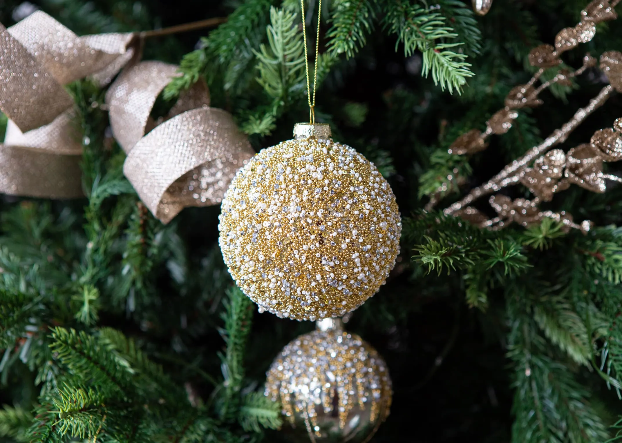 A lifestyle image of the Gold Round sparkle on a Christams tree from EZ Living Furniture.