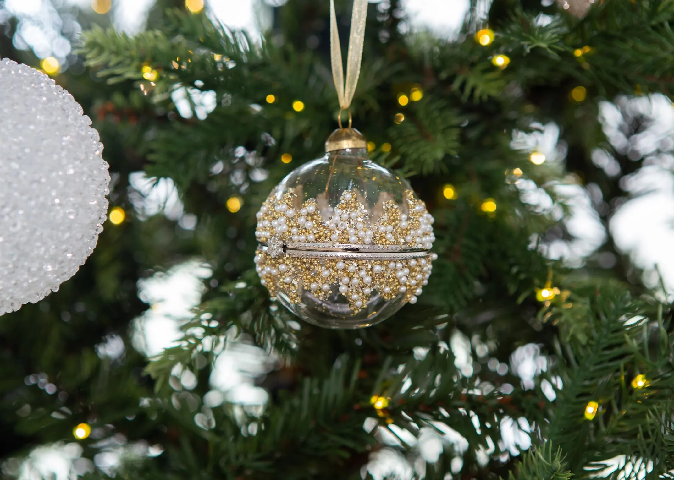 A lifestyle image of the Sparkle locket bauble on an EZ Living Furnitures Christmas tree.