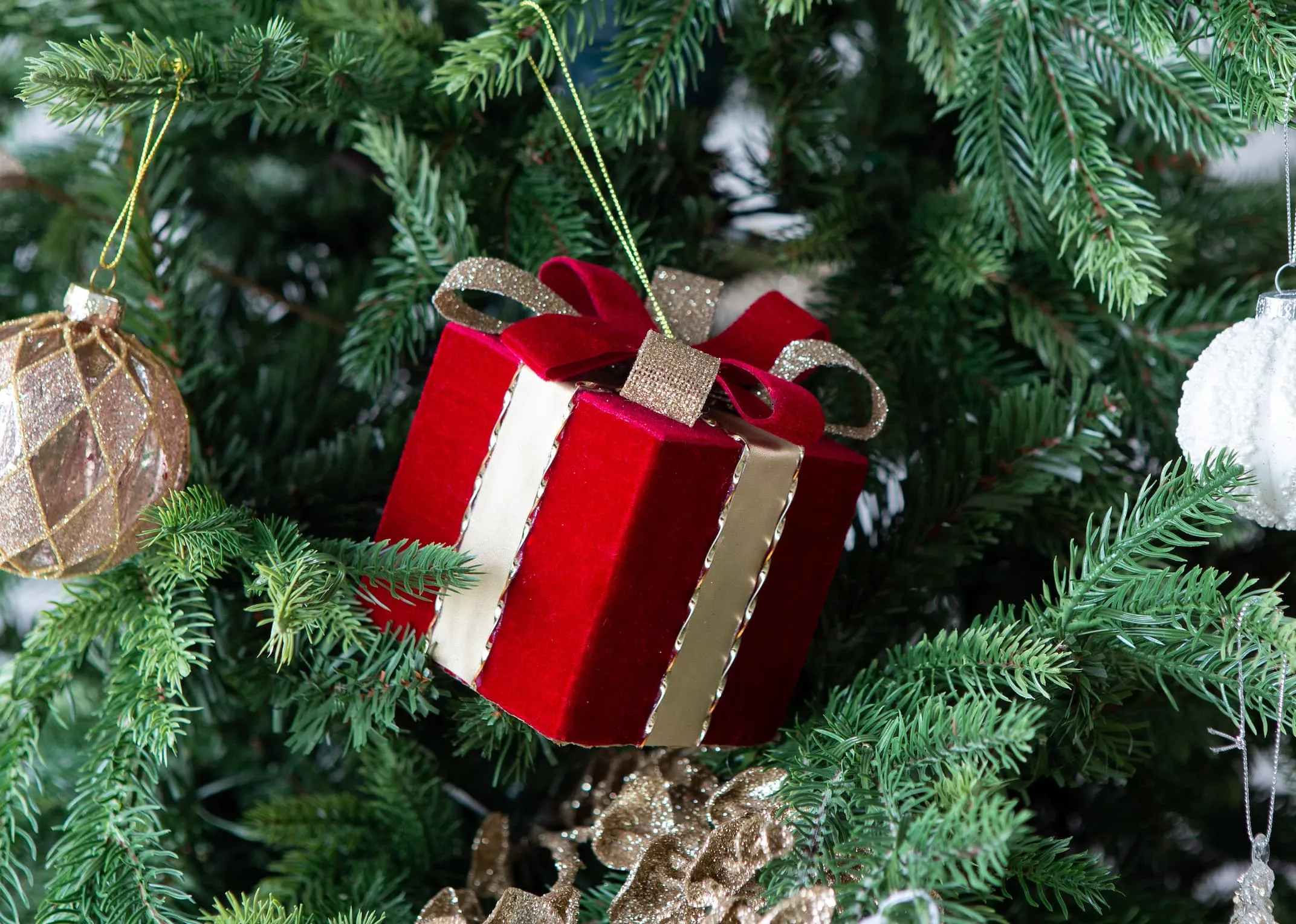 A lifestyle image of the red velvet gift box on an EZ Living Furniture Christmas tree.