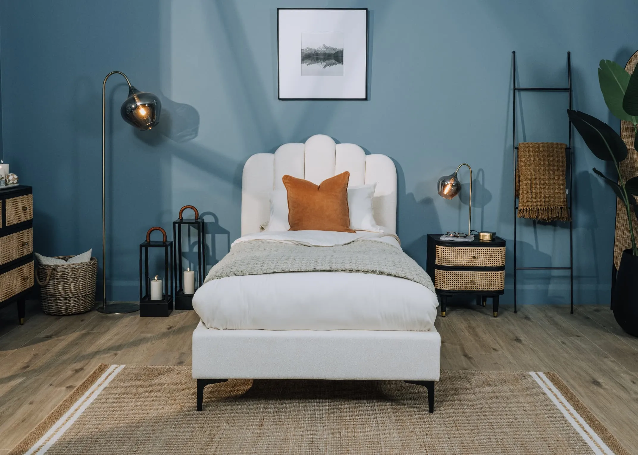 A lifestyle image of the FAye bedframe with lenny lockers and rakel bronze floor lamp.