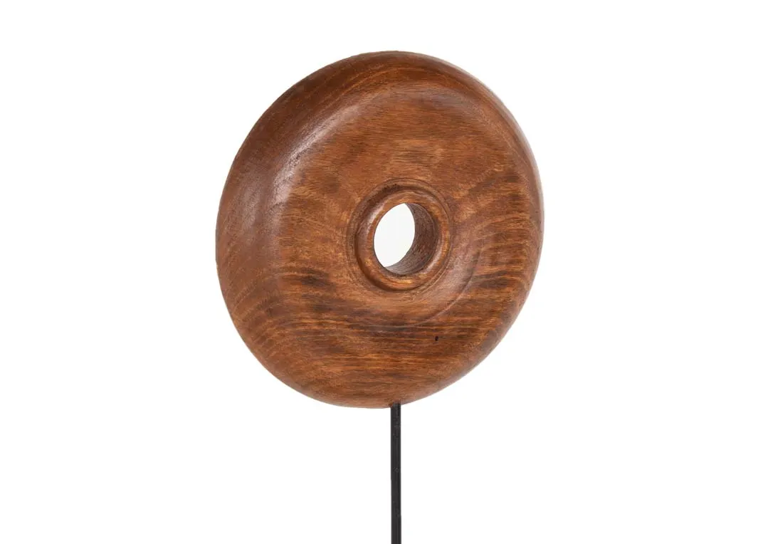 A dark brown wood round ornament with metal stand from EZ Living's Olumi range.Closeup of texture