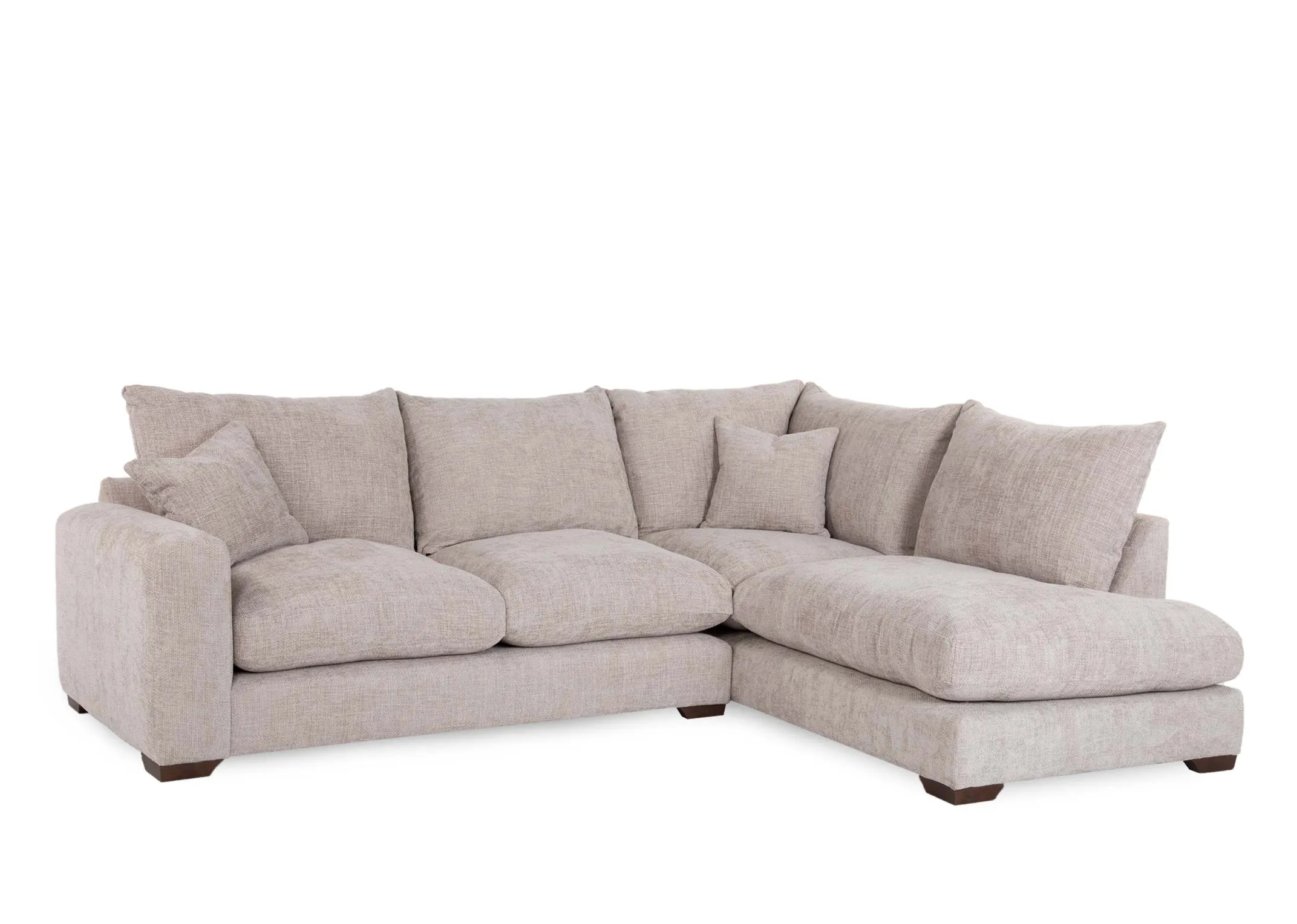 A beige fabric corner sofa with RHF lounger from EZ Livings Aurora range. Angled view of plump back cushions