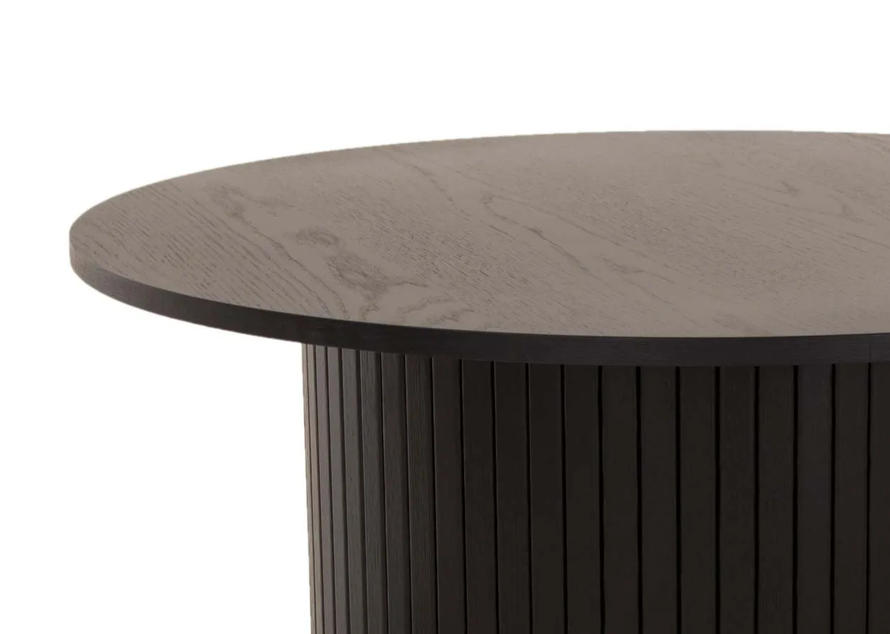 A round black oak coffee table with a slatted base from EZ Livings Nola range. Closeup of textured worktop