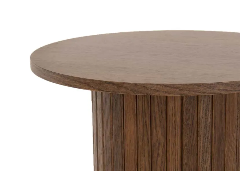 A round smoked oak lamp table with cylindrical slatted base from EZ Livings Nola range. Closeup of textrued wood top