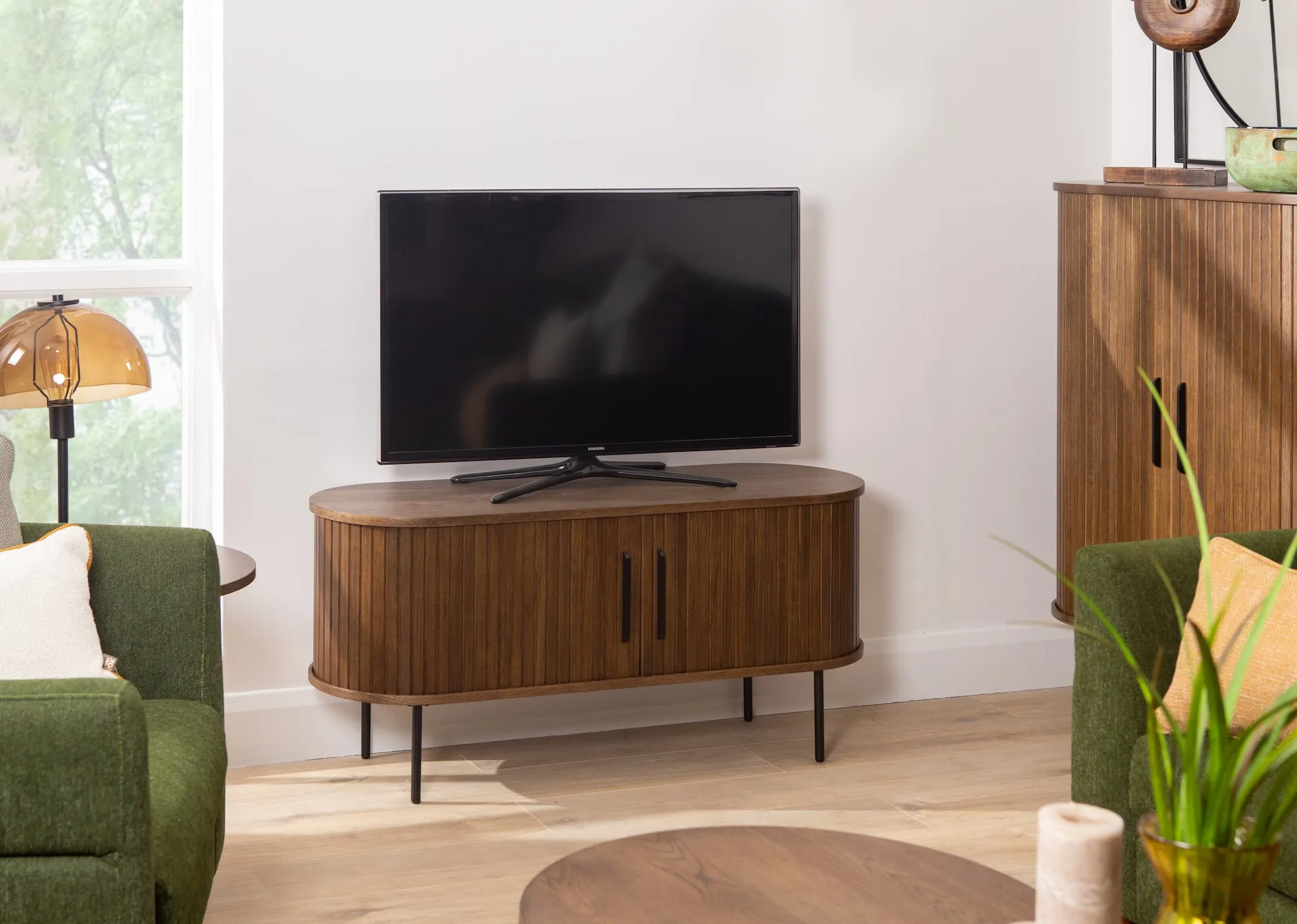 A lifestyle image of the Nola smoked oak tv unit closed from EZ Livings Living Range.