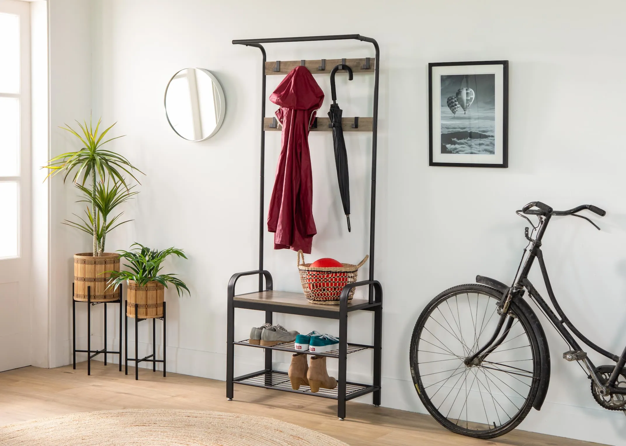 A lifestyle image of the Barrow Coat Stand with baskets and shoes with coat
