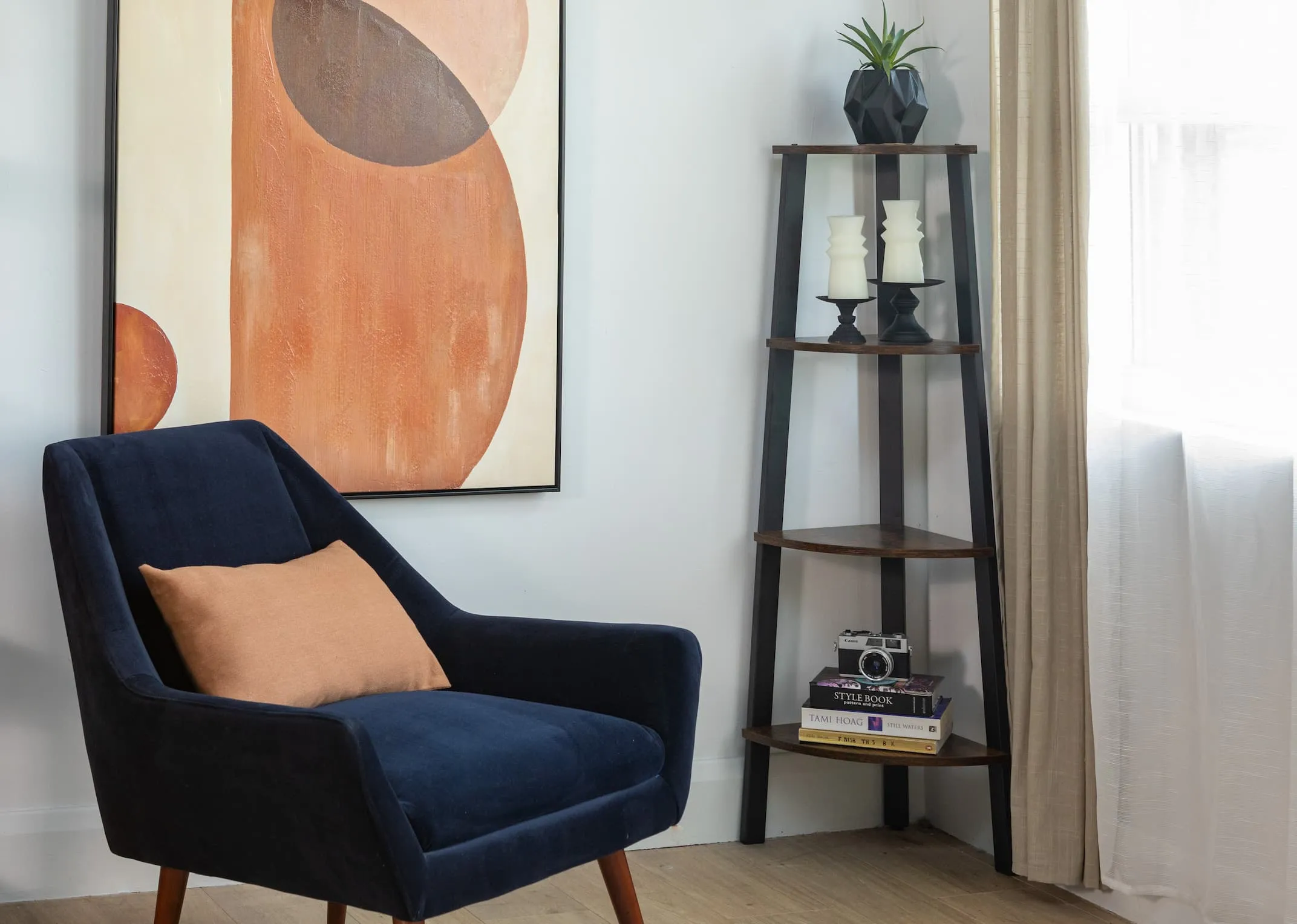 A lifestyle image of the Karo corner shelf with Janey chair with Perception canvas