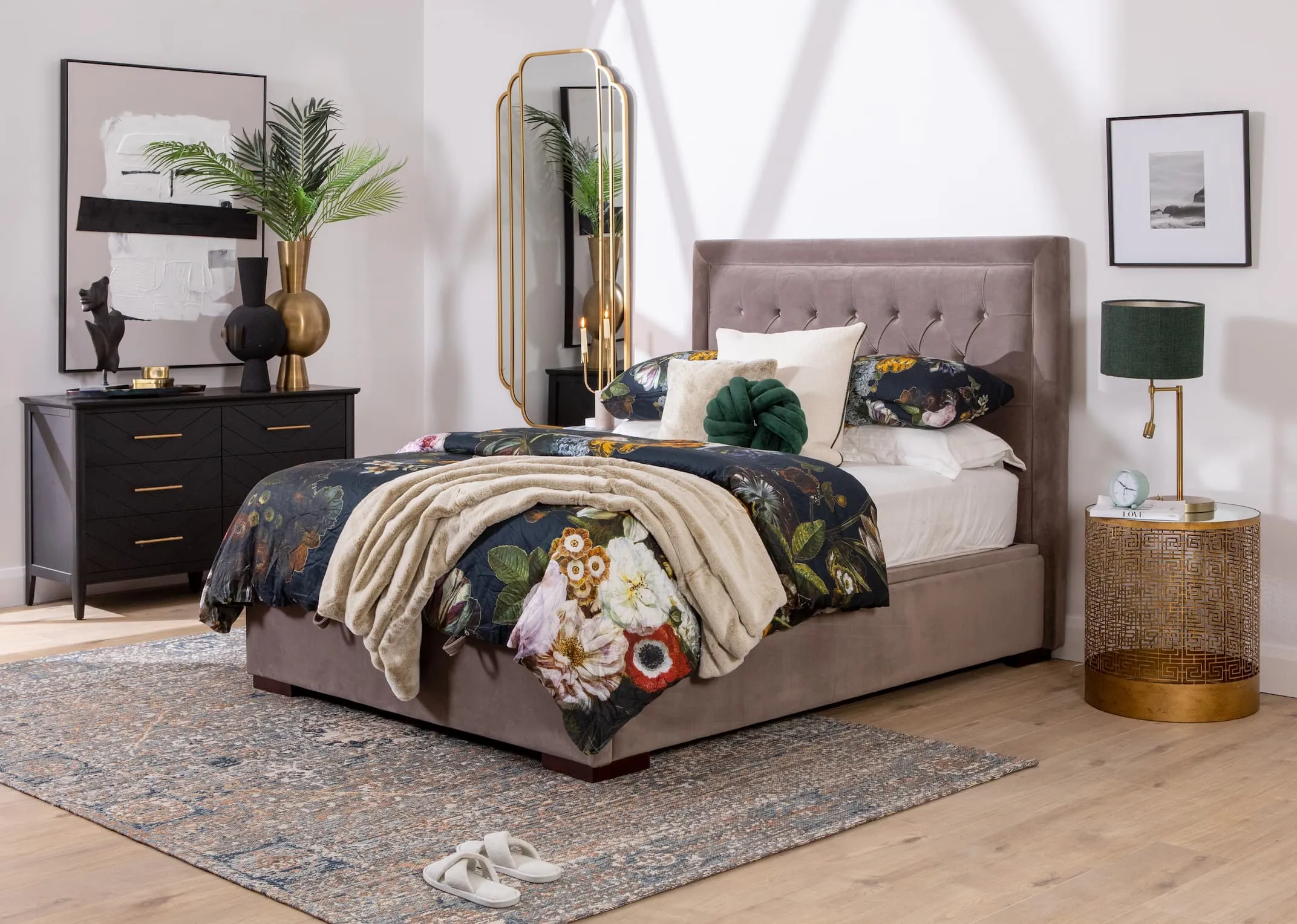 A lifestyle image of the Majestic taupe bed closed to reveal under bed storage and chevron black chest of drawers