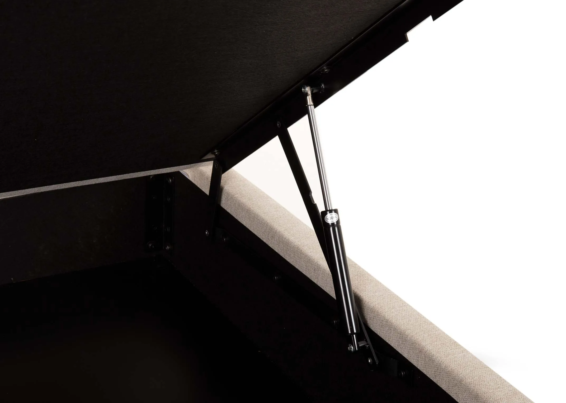 A double cream fabric ottoman bed from EZ Livings Majestic range. Closeup of hinges on base