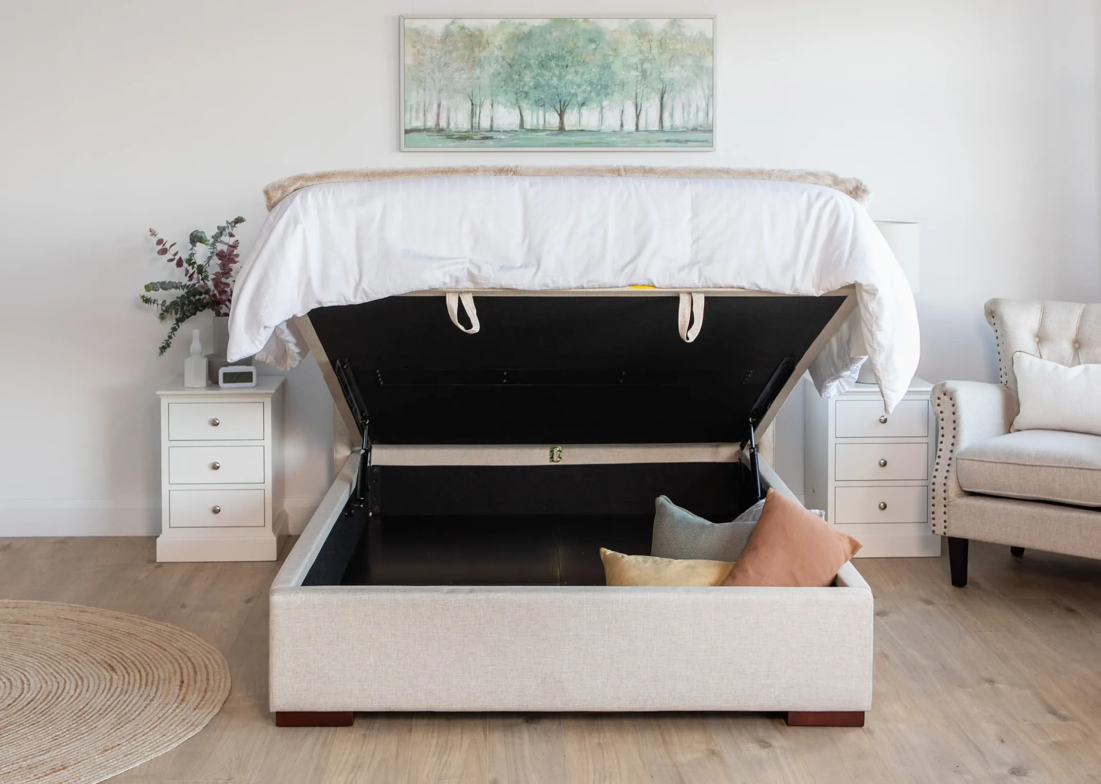 A lifestyle image of the Chester Bed closed and dressed in white linen with rivendale lockers and Retro lamp with Daydream canvas