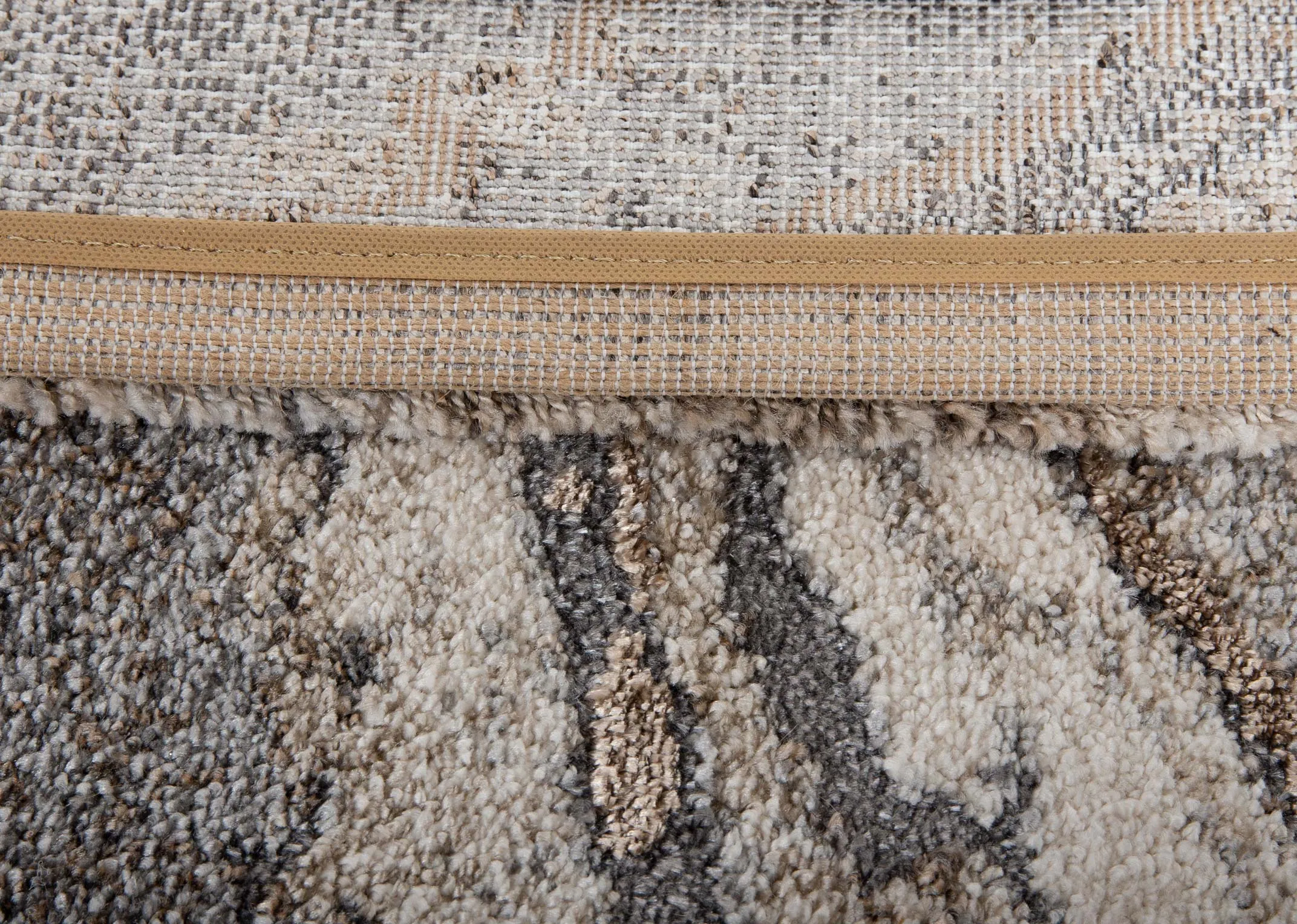 cream brown and grey print rug from EZ Livings Avanti range. Closeup of underlay
