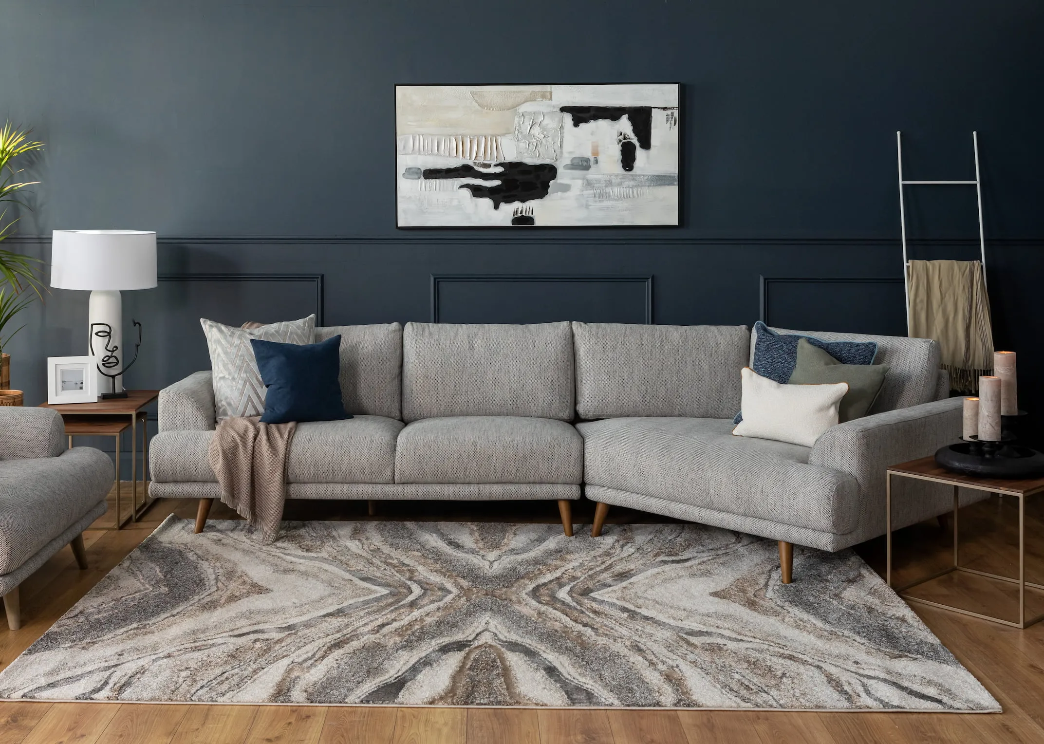 A lifestyle image of the Legend Corner group with Reaction canvas and Avanti rug