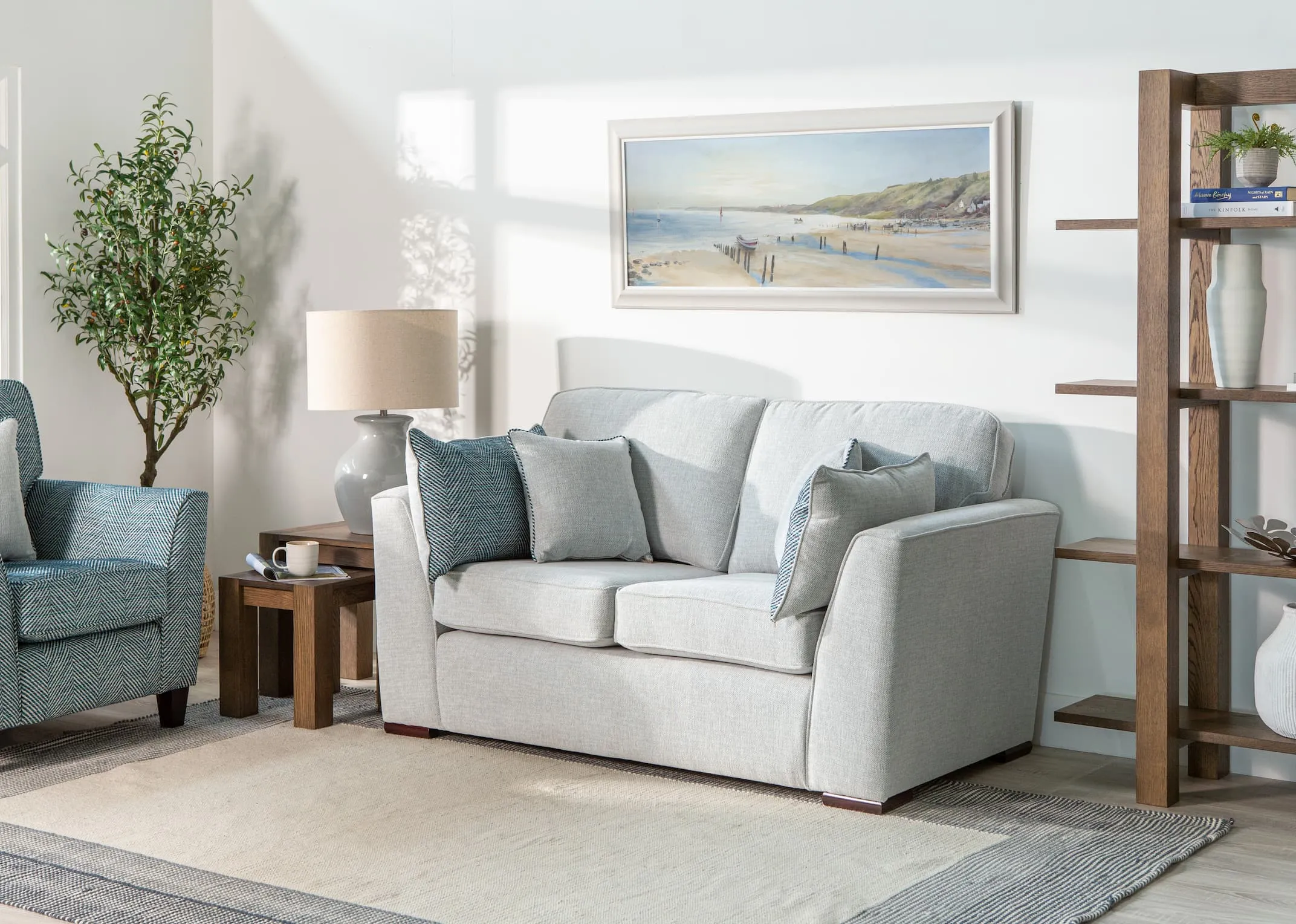 A lifestyle image of the Santorini 3 Seater with Turin Bookcase & Nest of tables