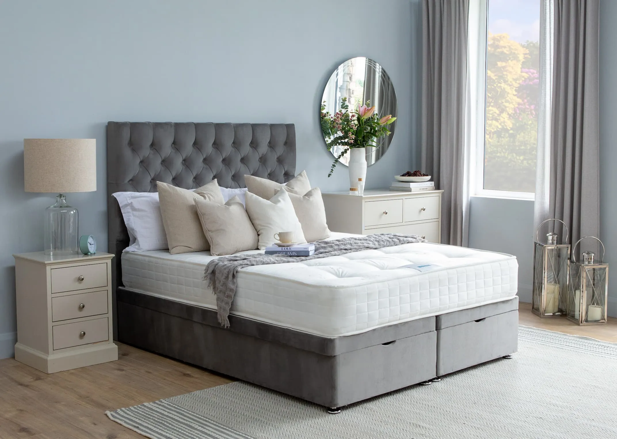 A lifestyle image for the Ottoman bed closed to reveal hidden storage and paired with the Palma Headboard.