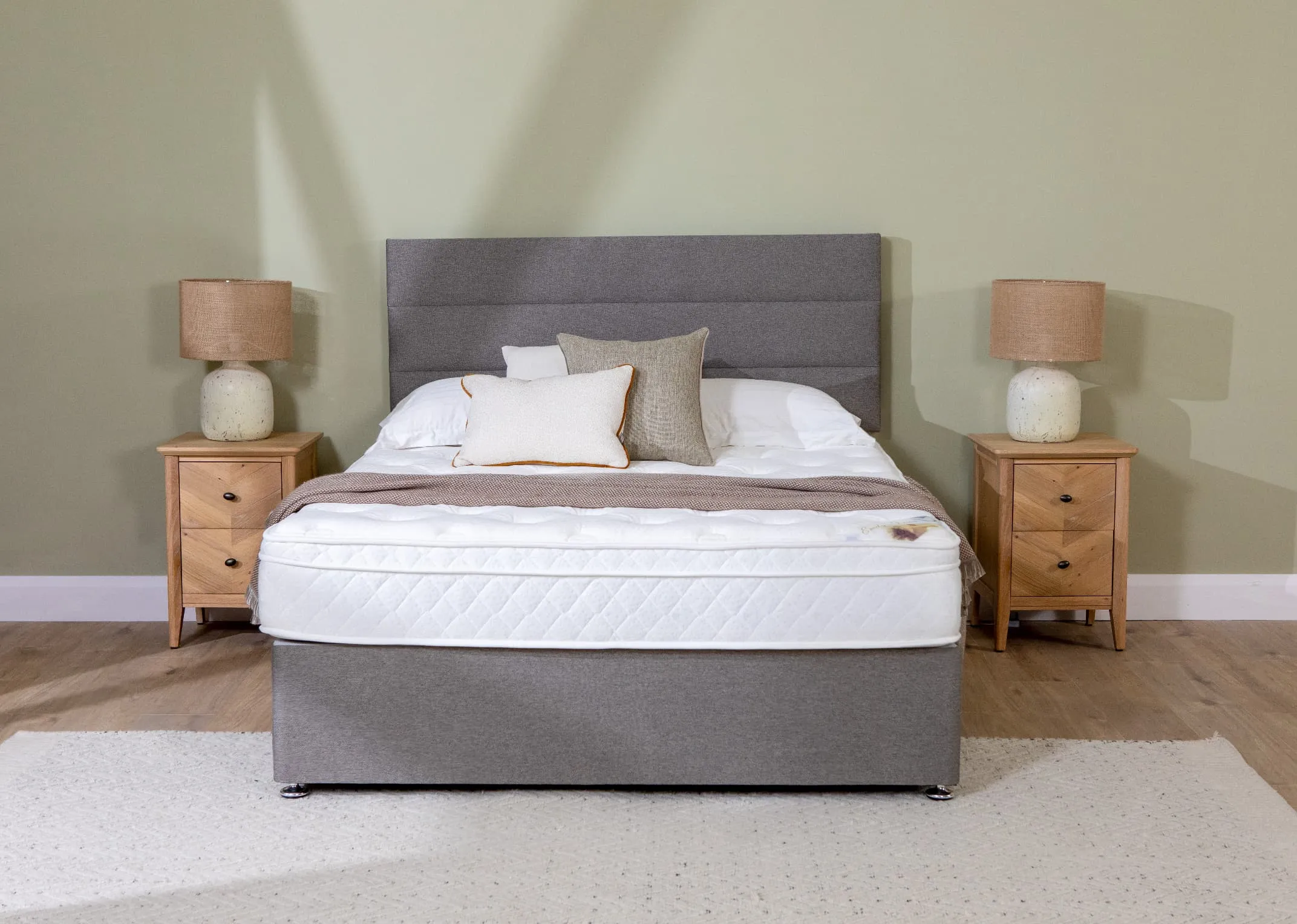 A lifestyle image of the Venice Divan with Moden 3 row headboard in linen with 2 chevron lockers.