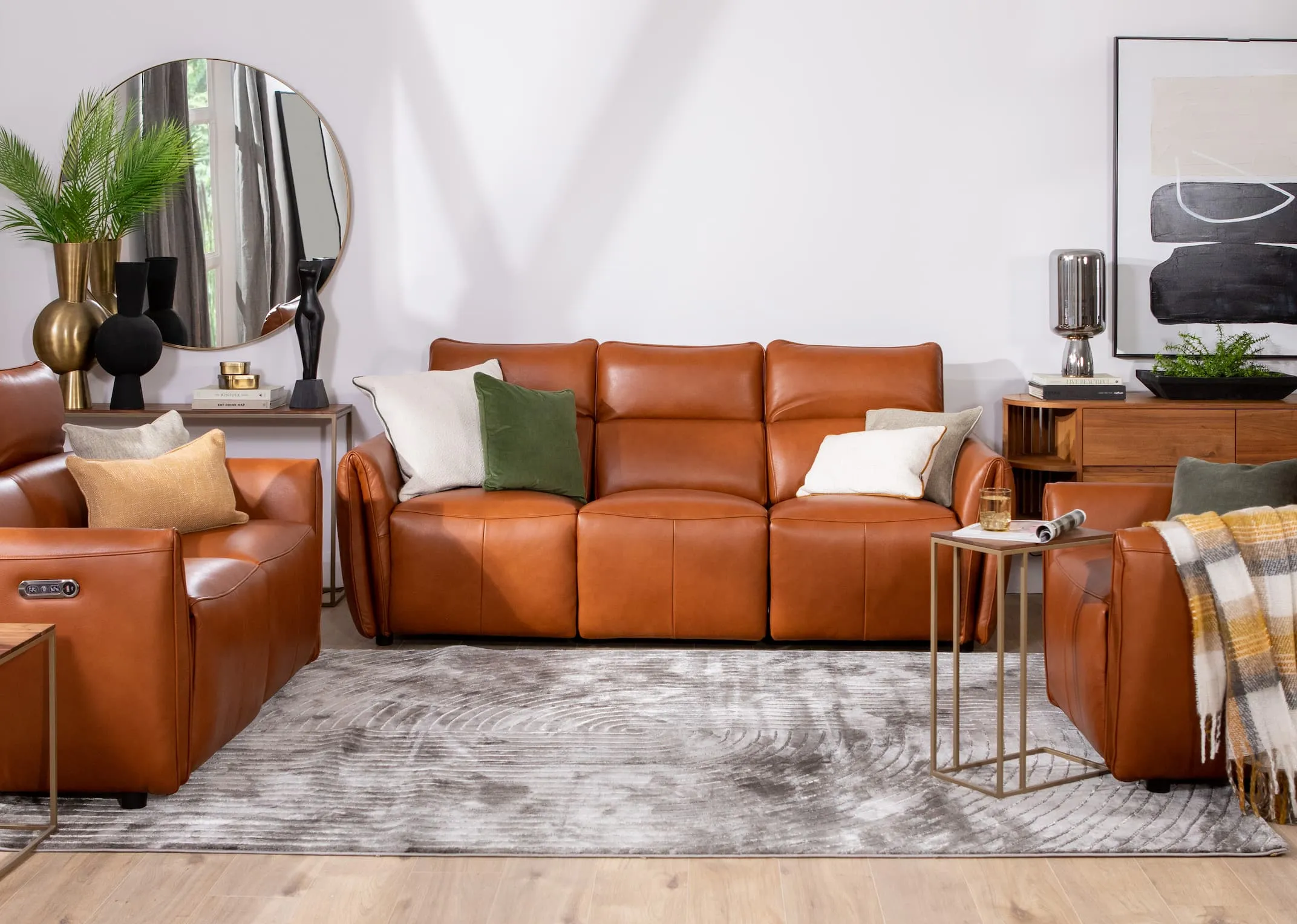 A lifestyle image of the Icon sofa range with 3 seater fixed with green & cream cushions with Frida rug and Aston tables