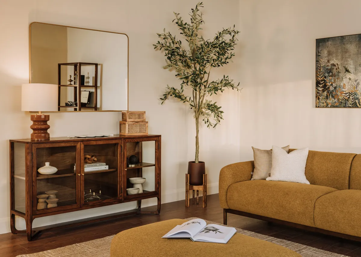 A lifestyle image of the Loft sofa with Cameo furniture and Fern gold mirror.