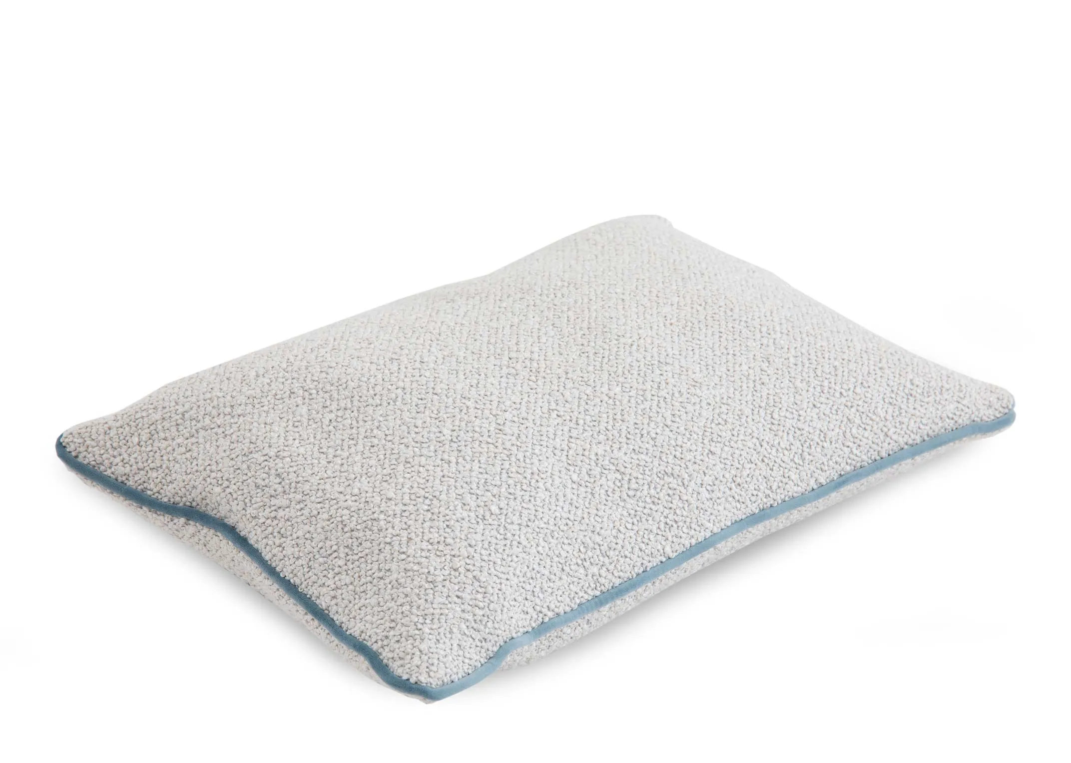 A ivory bolster cushion with pale blue trim from EZ Livings Leighton range.Angled view