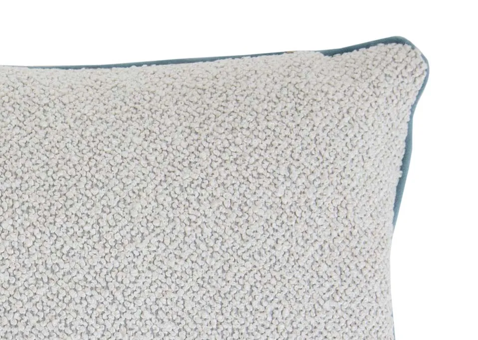 A ivory bolster cushion with pale blue trim from EZ Livings Leighton range. Closeup of blue piping around edges.