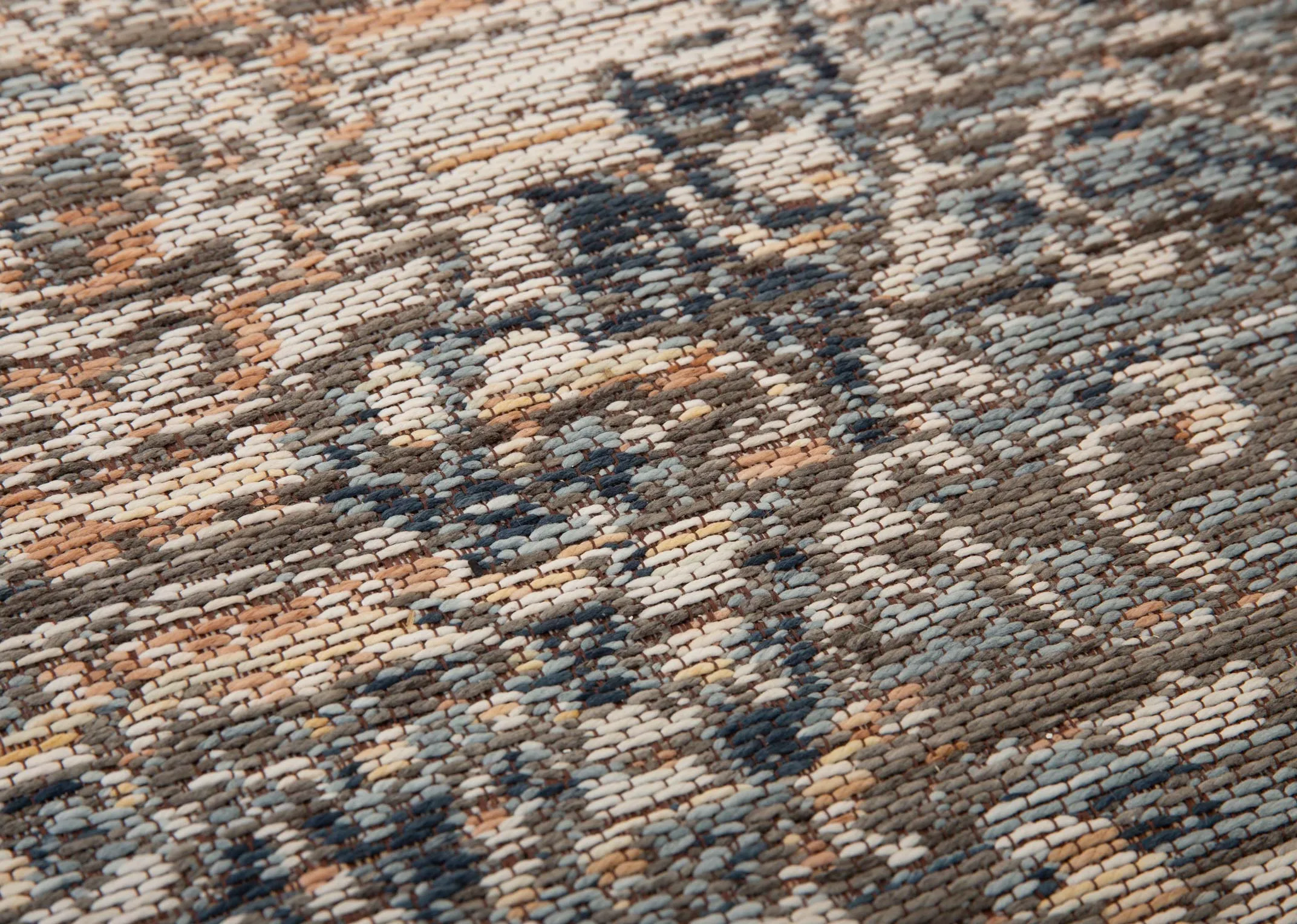 A rust grey & silver print rug from EZ Livings Maxima range. Closeup of texture and print