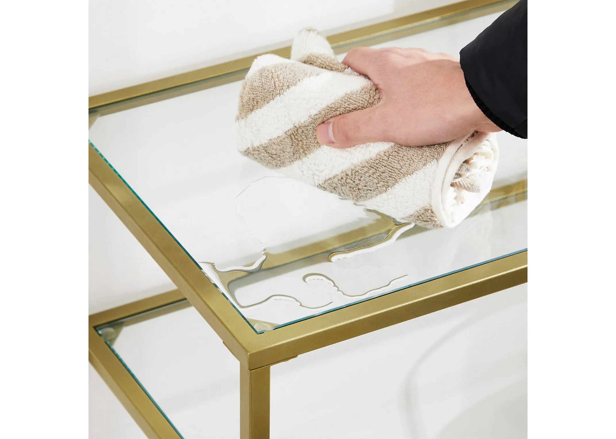 A lifestyle image of the Zafon Console Table from an upper angle showing capacity and glass helves