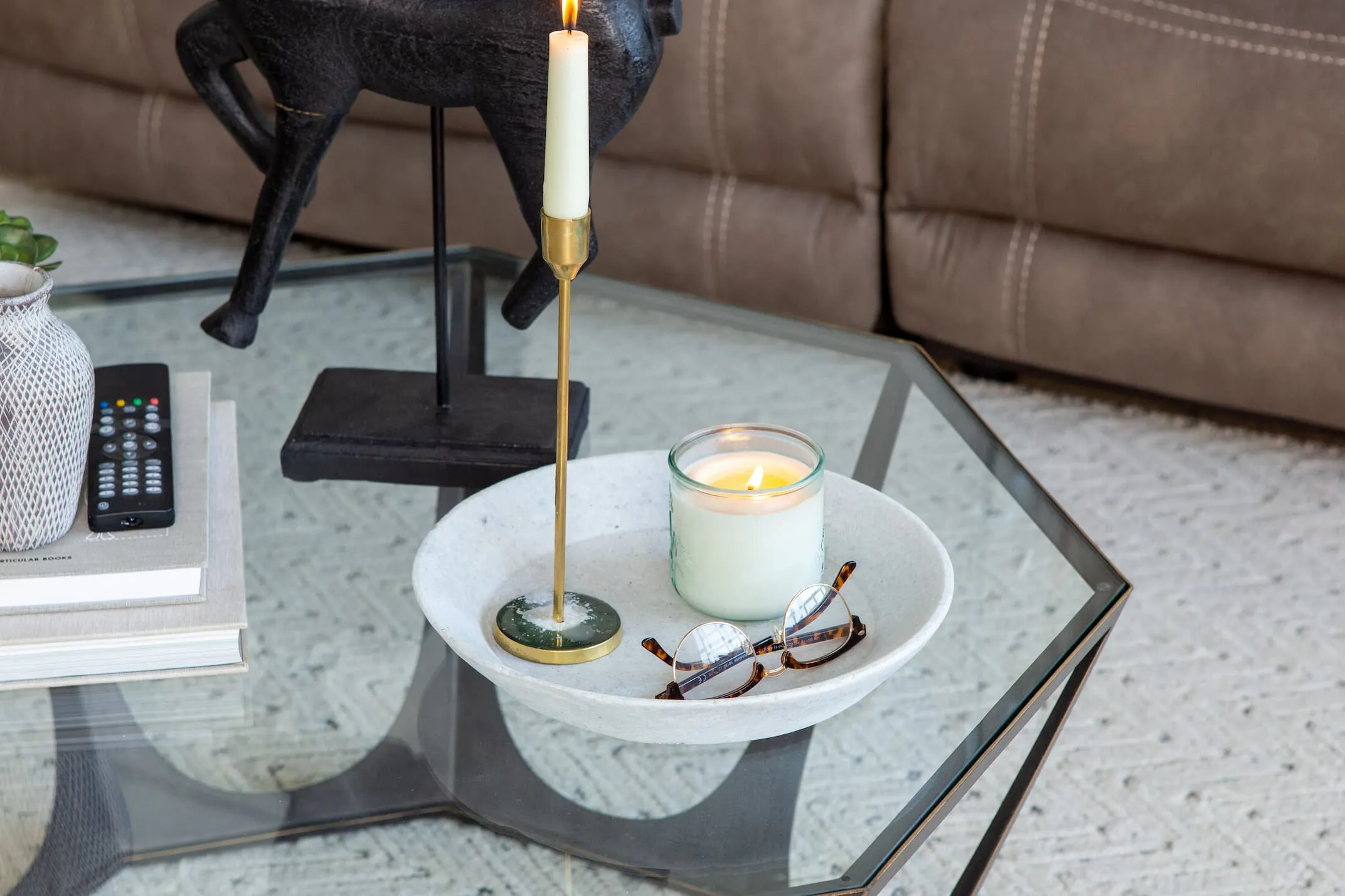 A lifestyle image of the Catalan coffe table with the Couzana dish and candles