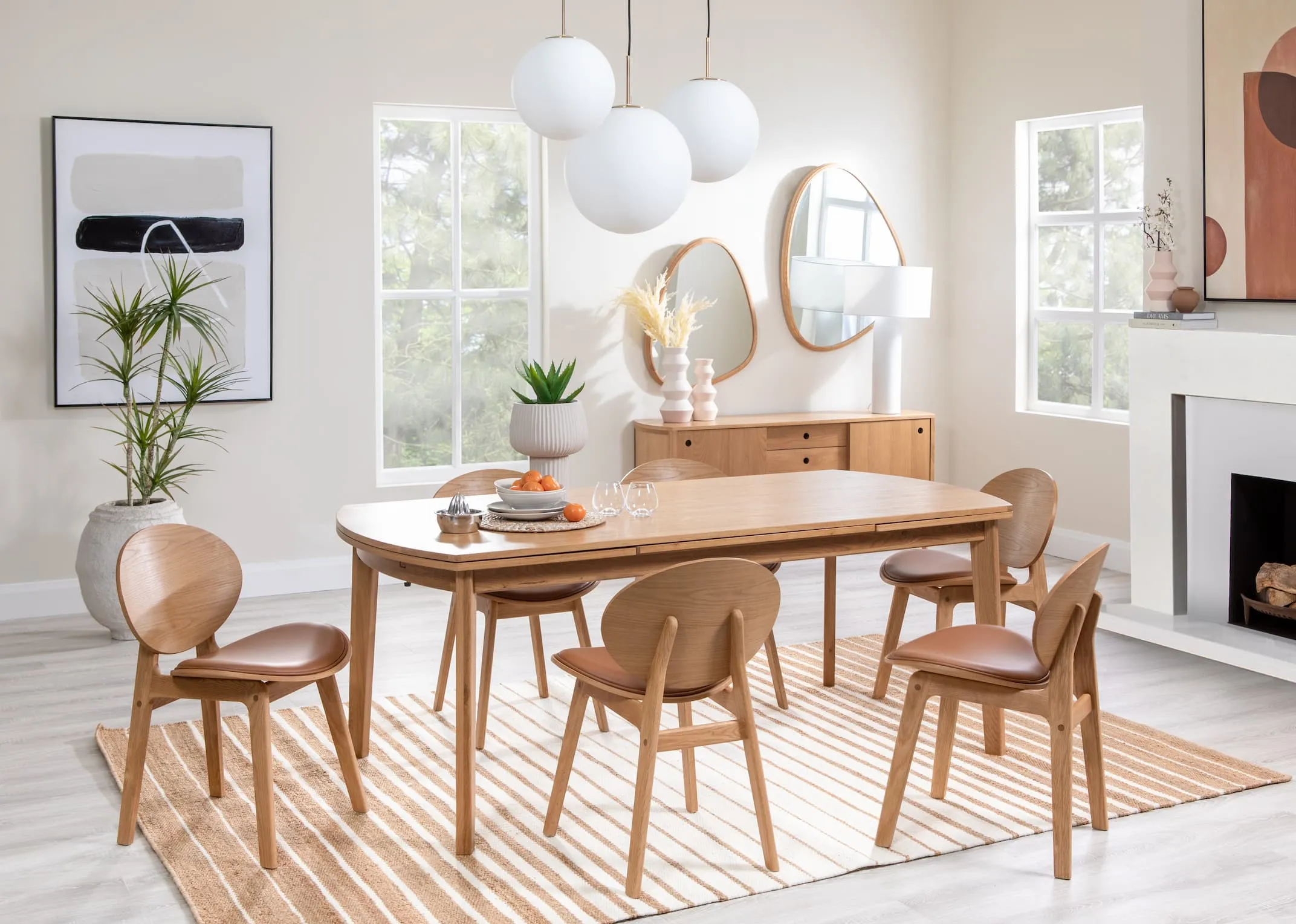 A lifestyle image of the Copenhagen dining table with sideboard and Ontario chairs with the Medina gold & white ceiling lights