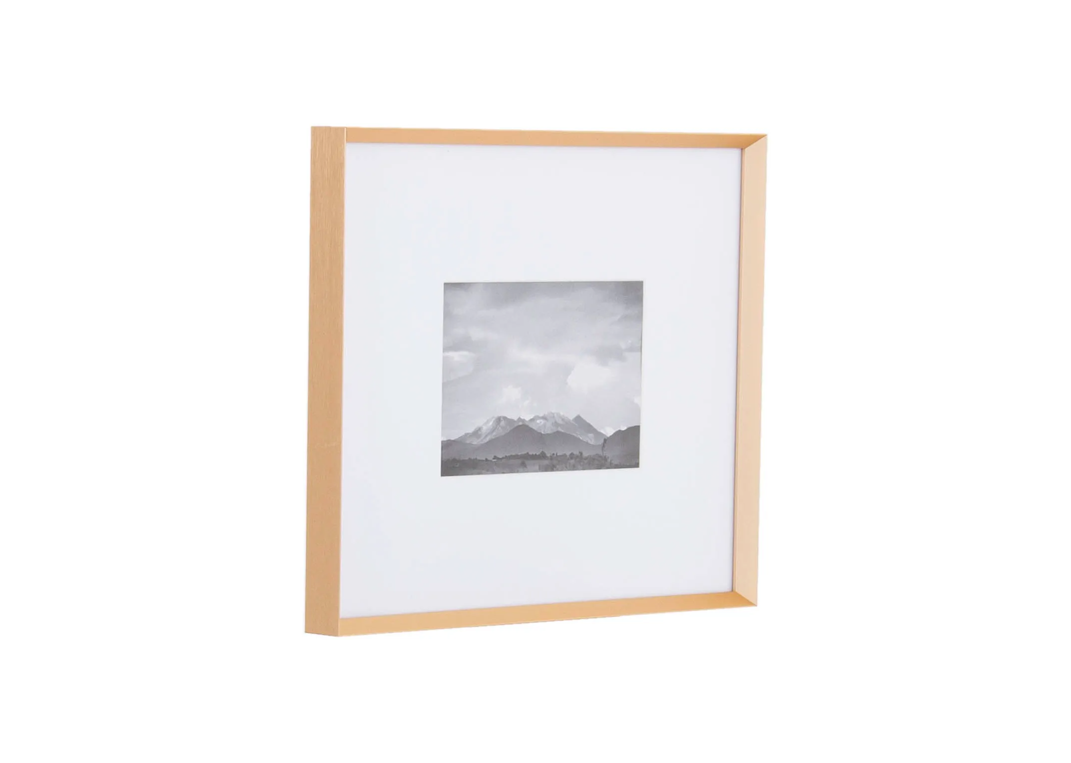 A small brass photo frame with wide white inlay from EZ Livings Arabel range. Angled view