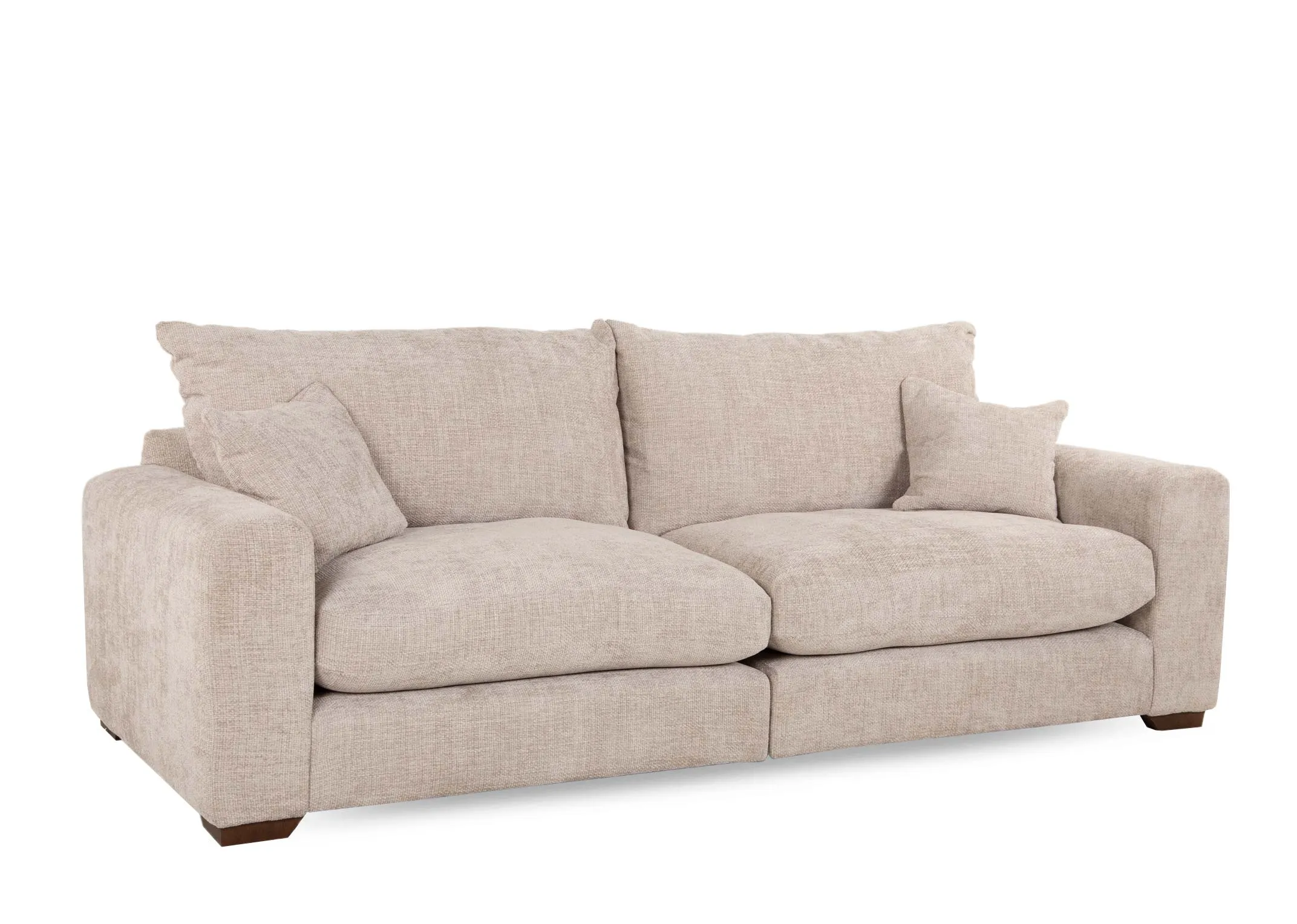 A beige fabric 4 seater sofa from EZ Livings Aurora range. Angled view of plump back cushions & 2 scatters