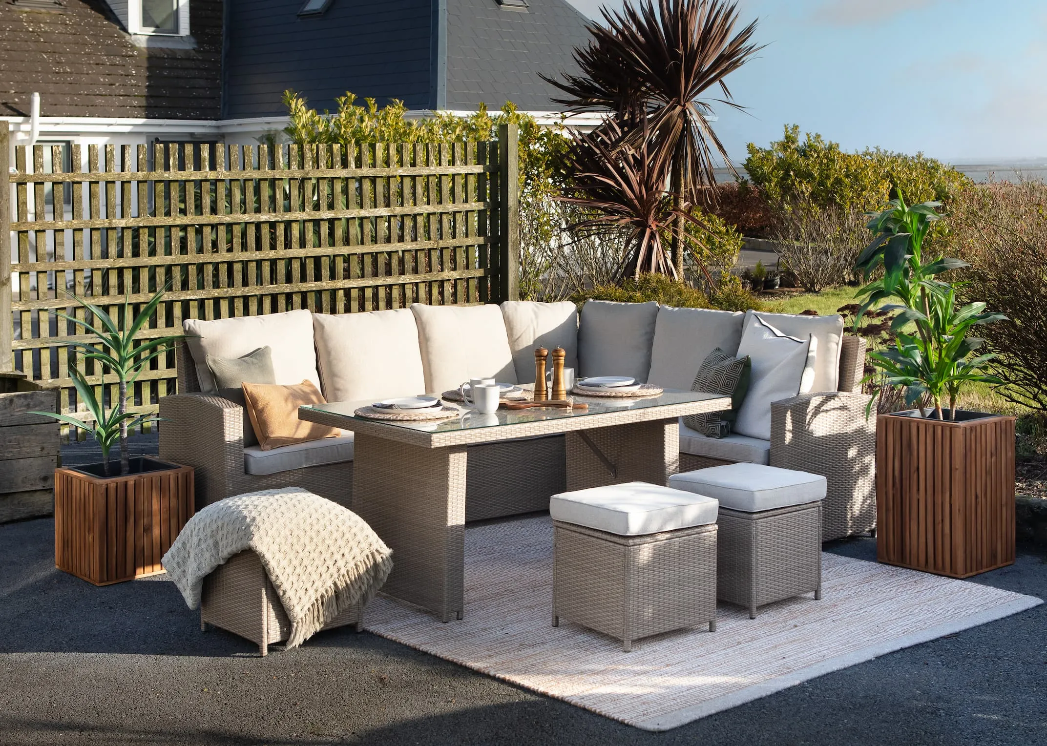 A lifestyle image of the Malaga Corner Garden sofa set with sofa