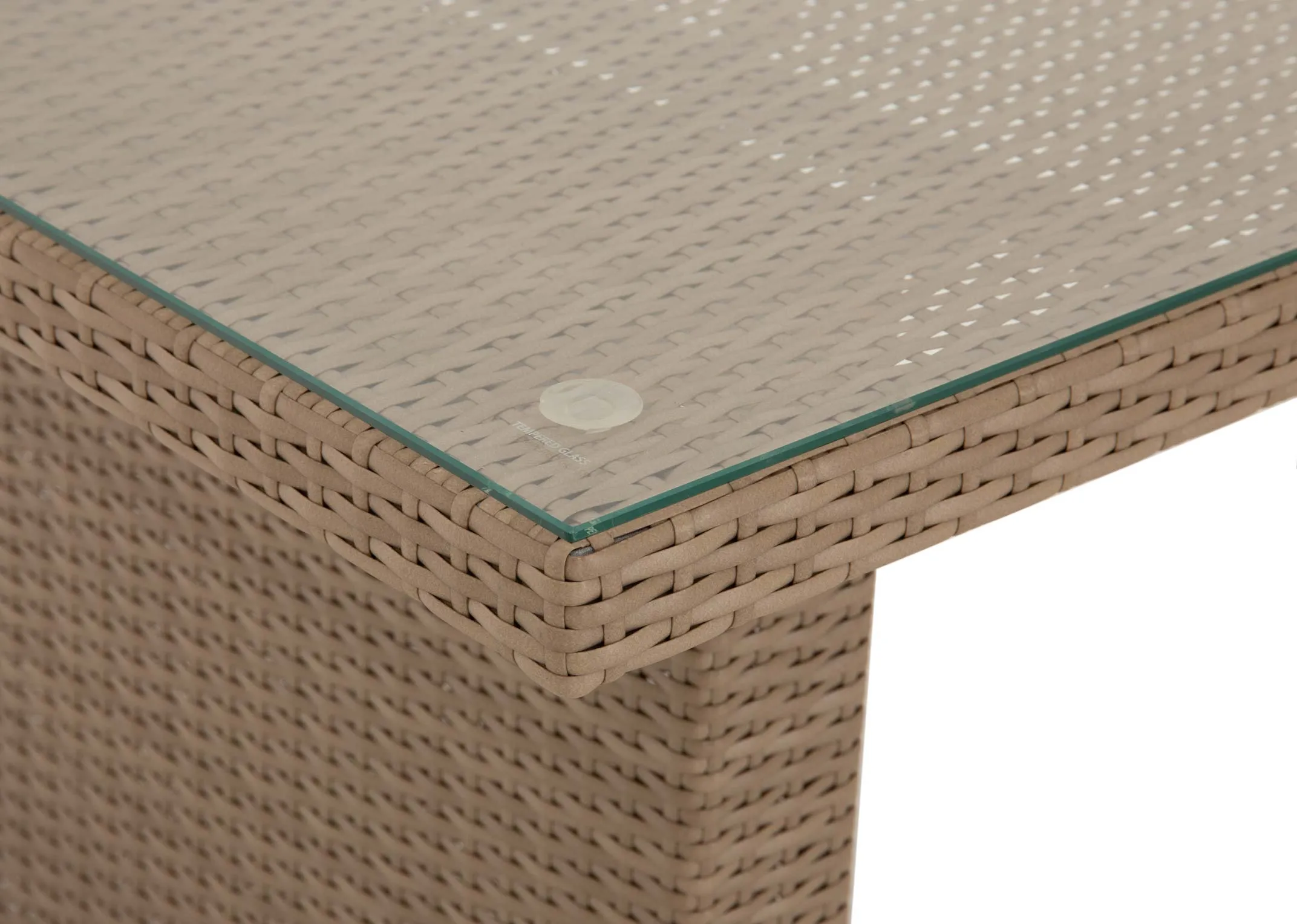 A closeup view of the light brown rattan garden dining table with glass table top from EZ Livings Malaga Garden range.