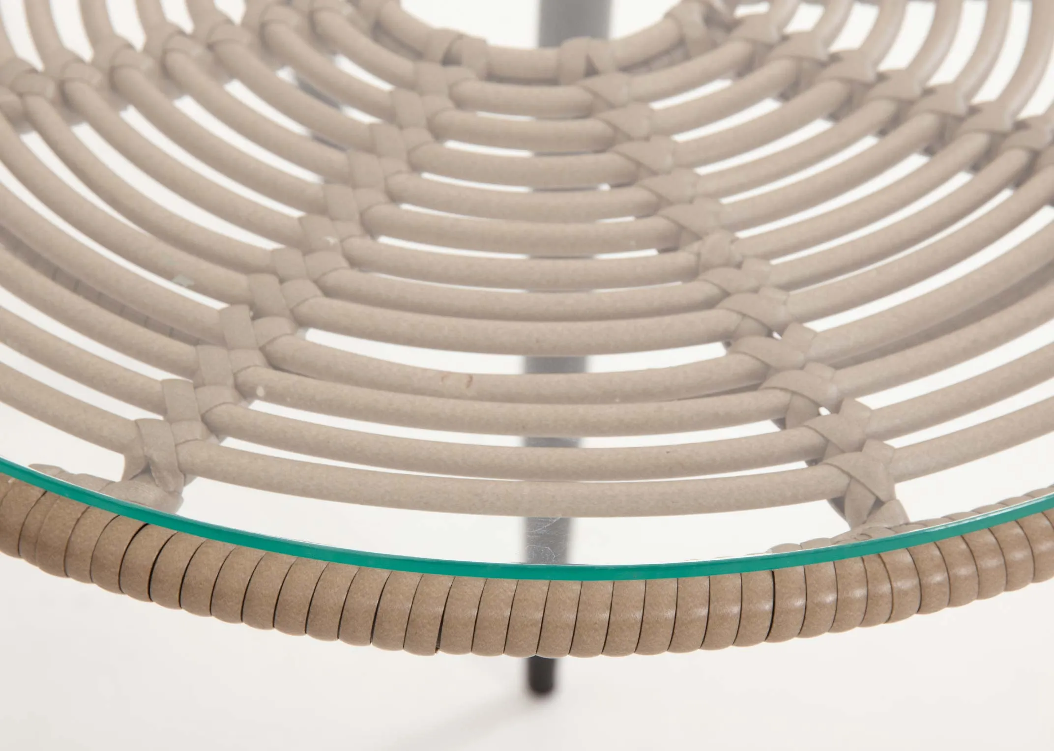 A bistro set with 2 wicker chairs and a small glass table from EZ Livings Menorca range.Closeup of glass table top with rattan base