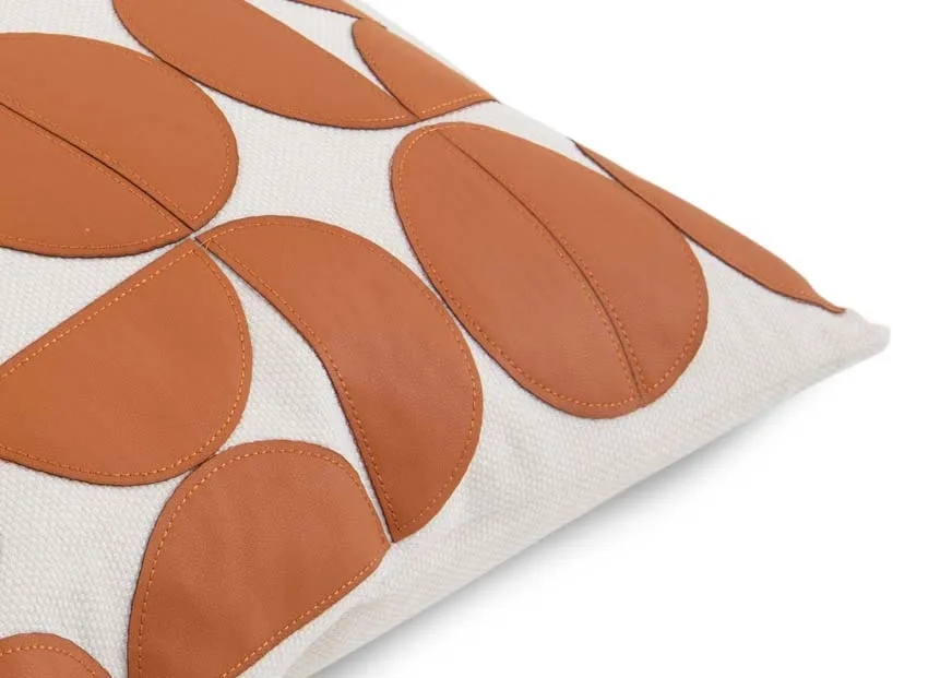 A tan & cream geo print cushion from EZ Livings Cushion range. Closeup of raised tan fabric on cream bacground.