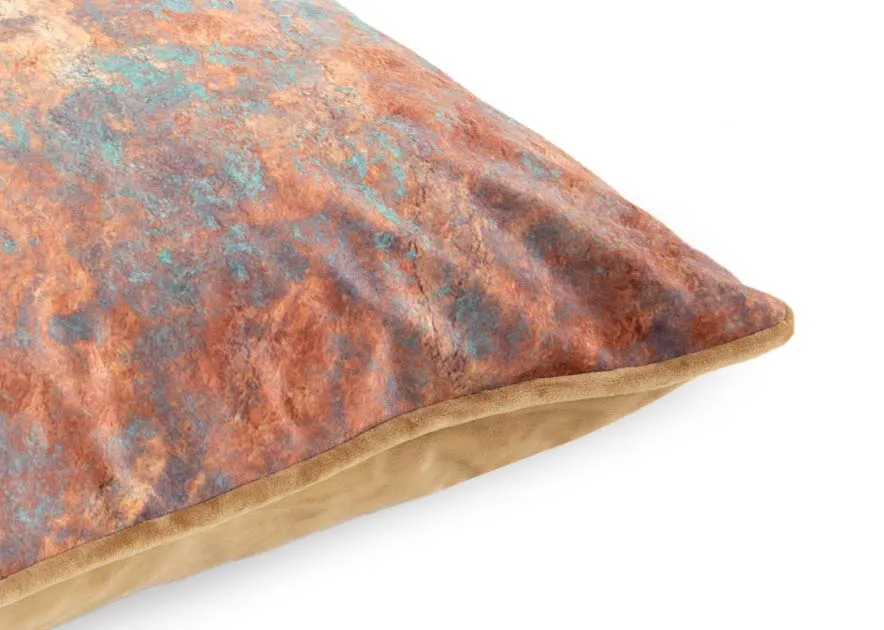 A rust cushion with teal patches from EZ Livings Cushion range. Closeup of gold piping