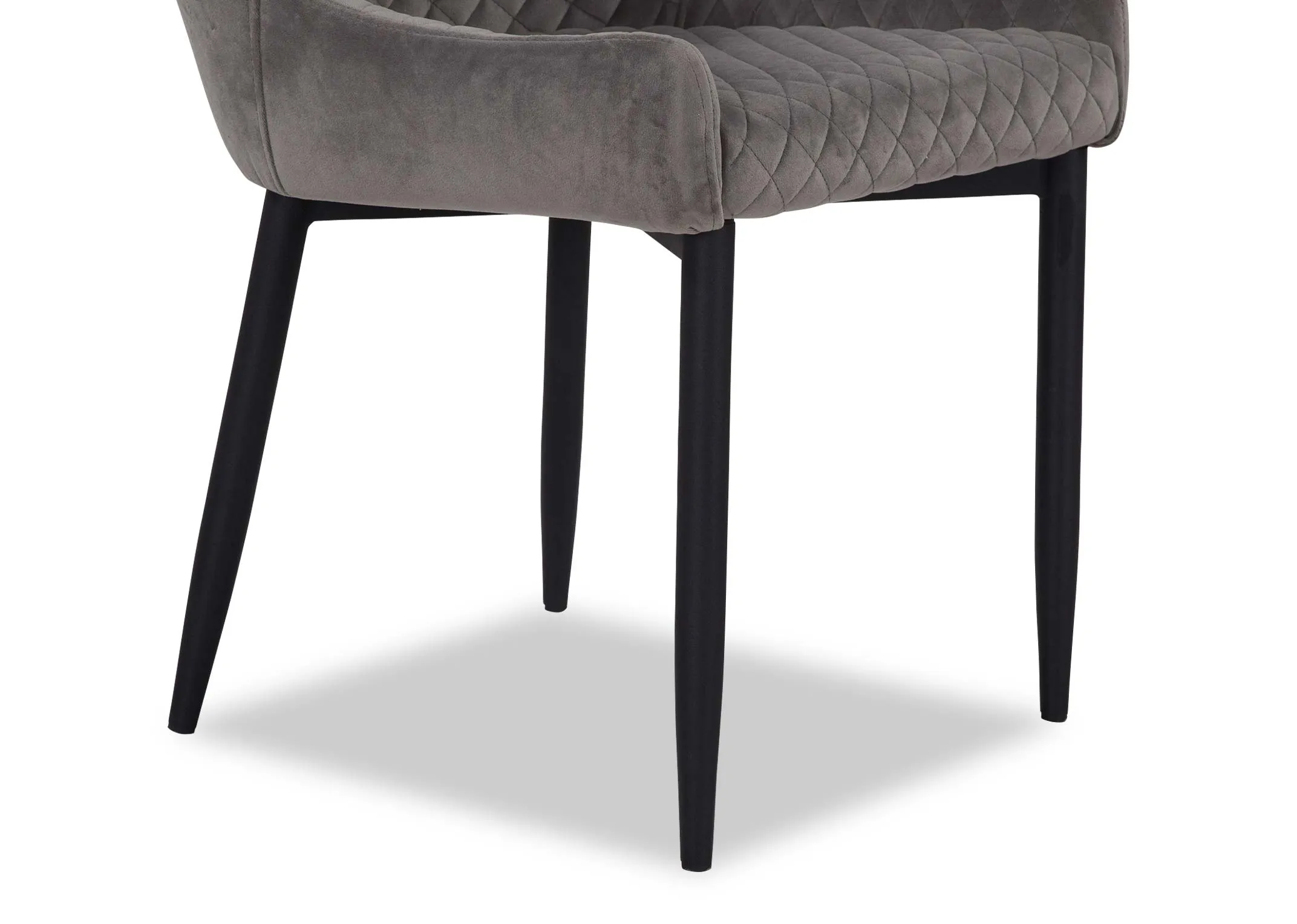 A grey velvet dining chair from EZ Livings Ottowa range. Closeup of black metal legs