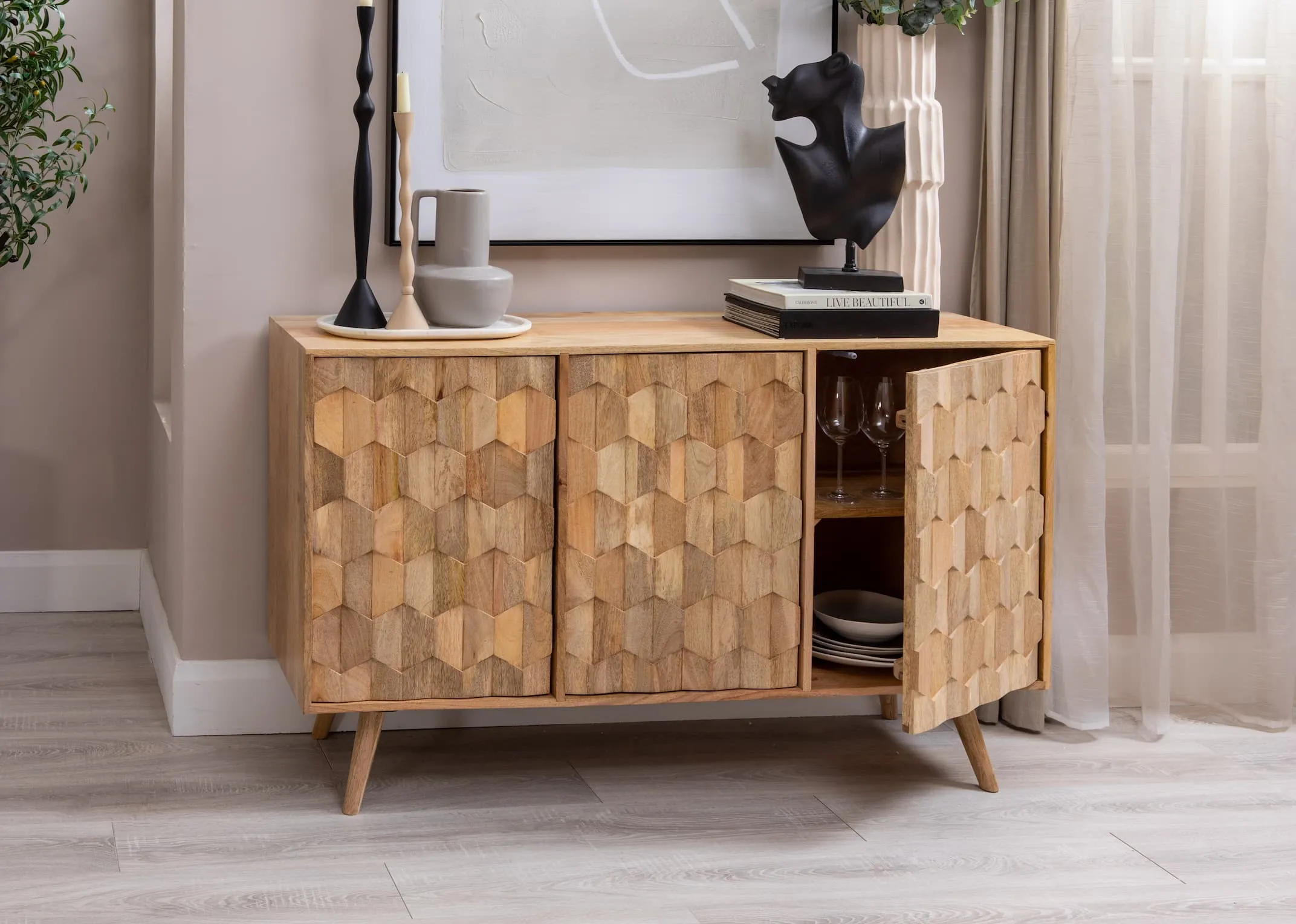 A lifestyle image of the Cologne sideboard with ornaments and vases on top