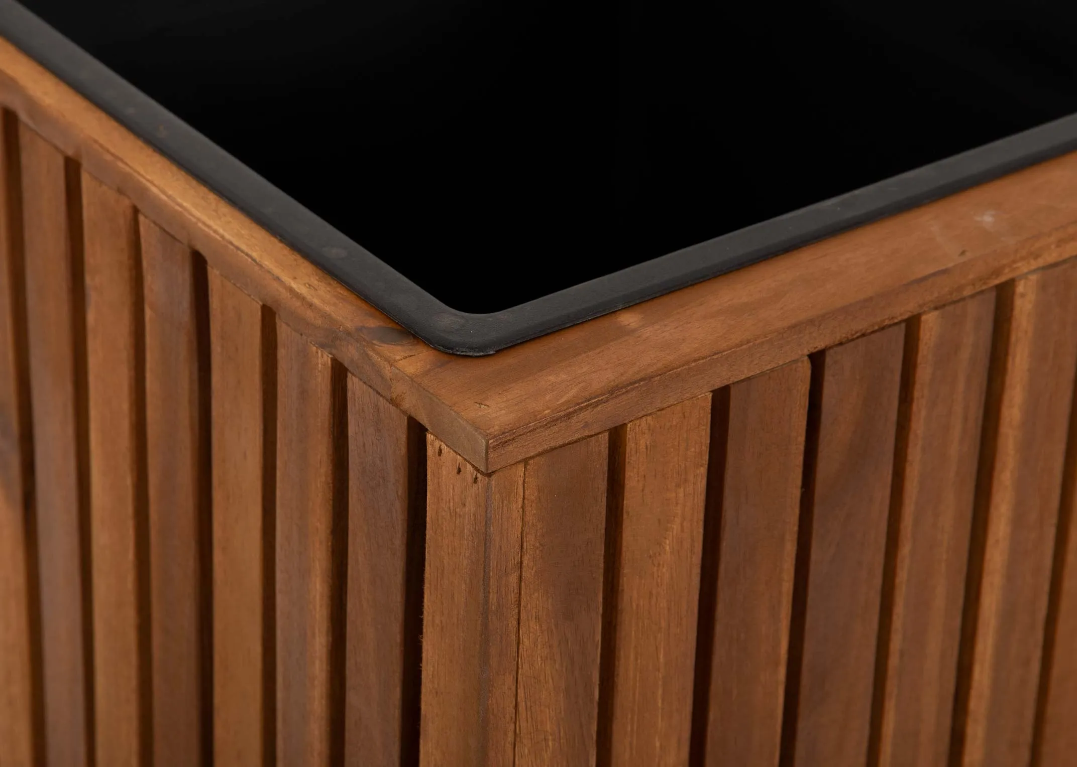 A brown slat wood rectangular planter from EZ Livings Santa Cruz range. Closeup of black plastic insert